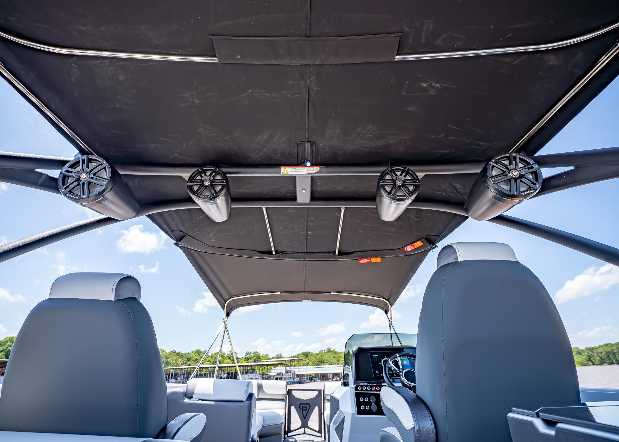 2025 Paradigm Damascus 266 Surf boat interior with speakers and canopy.