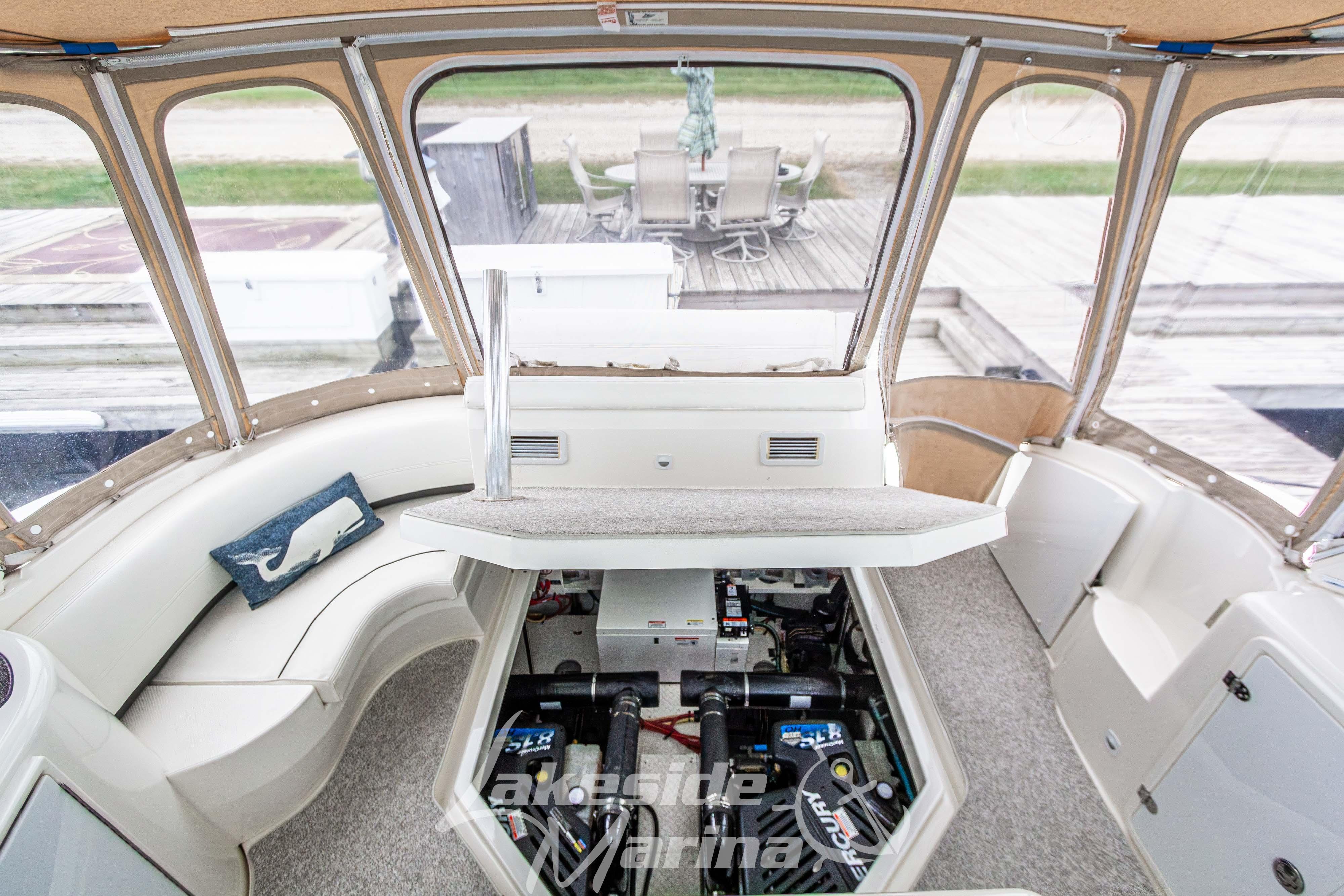 2006 Cruisers Yachts 420 Express interior with engine compartment open, showcasing seating and decor.