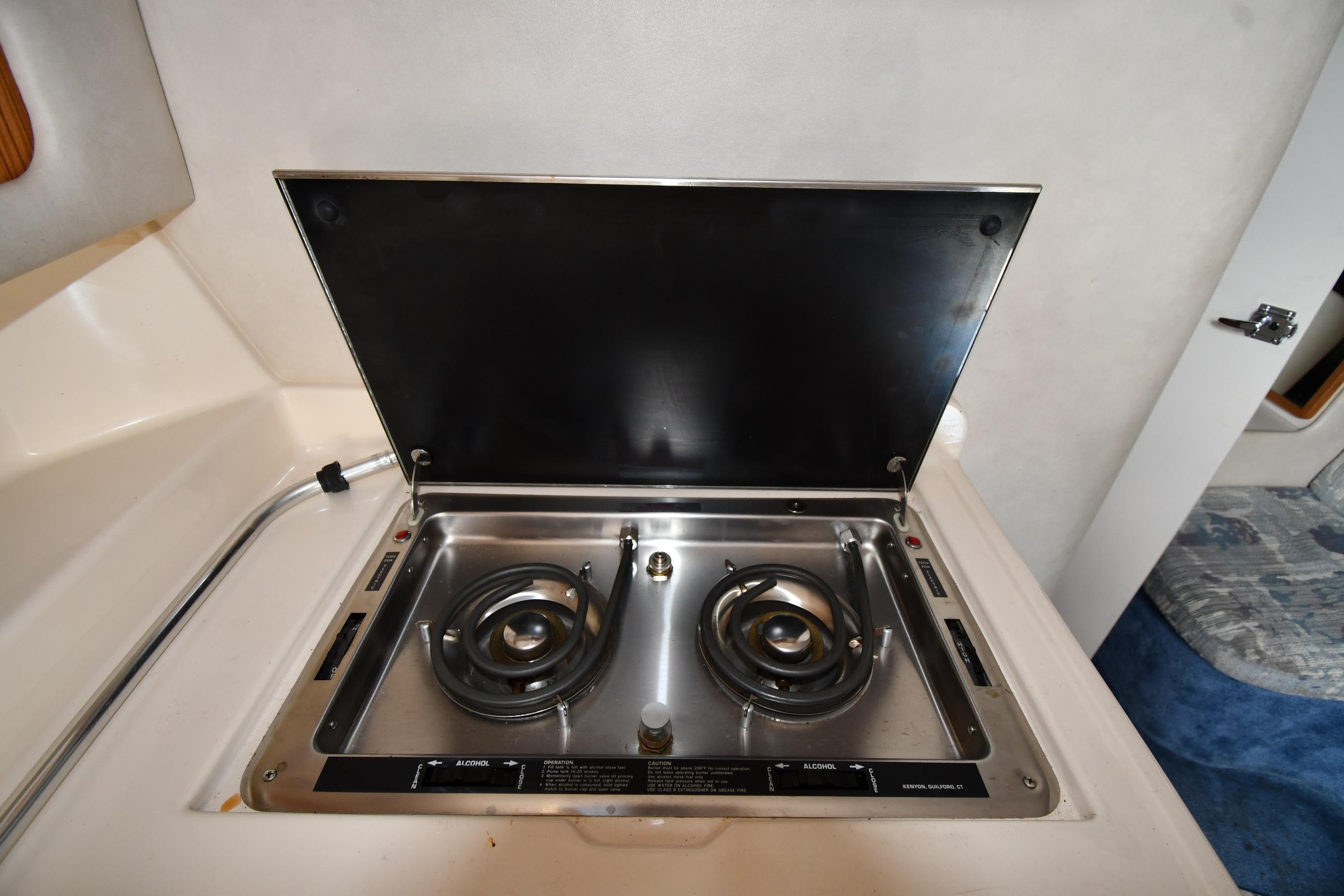 1993 Sea Ray 300 Sundancer boat stove with two burners in cabin kitchen area.