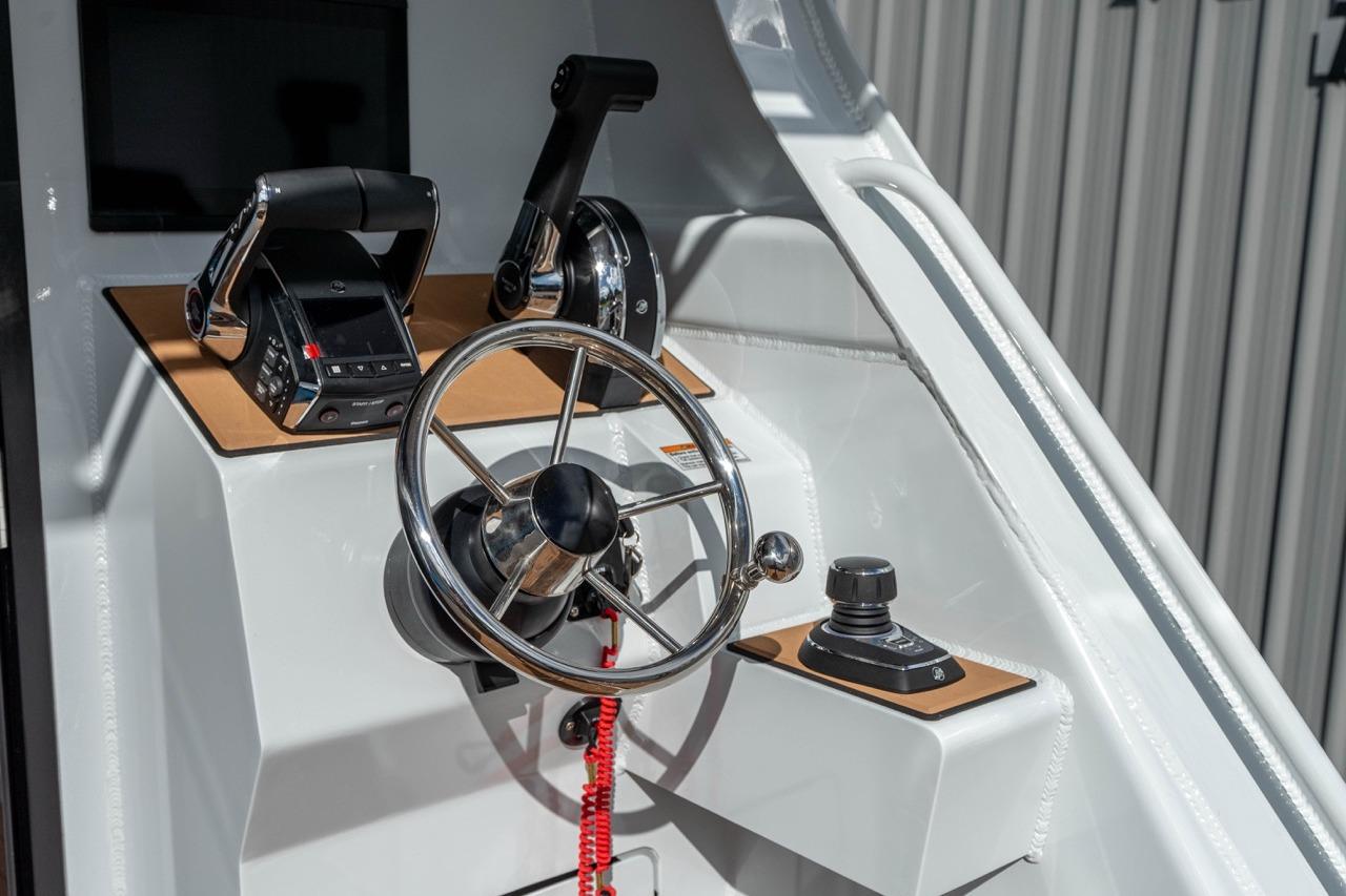 Steering console of 2025 Makaira Gen 3 36 boat with modern controls and wheel.