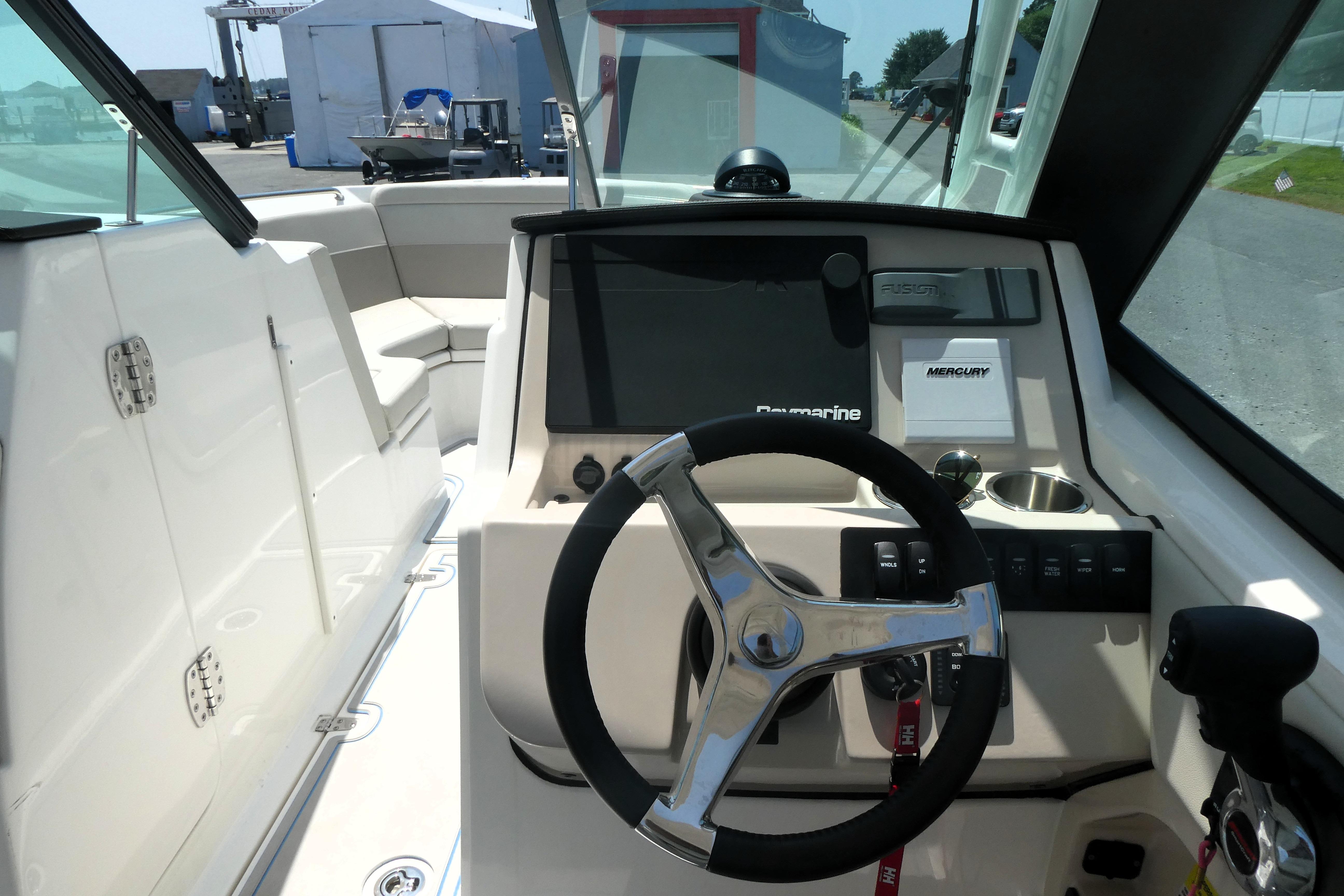 2022 Boston Whaler 240 Vantage boat cockpit with steering wheel and control panel.