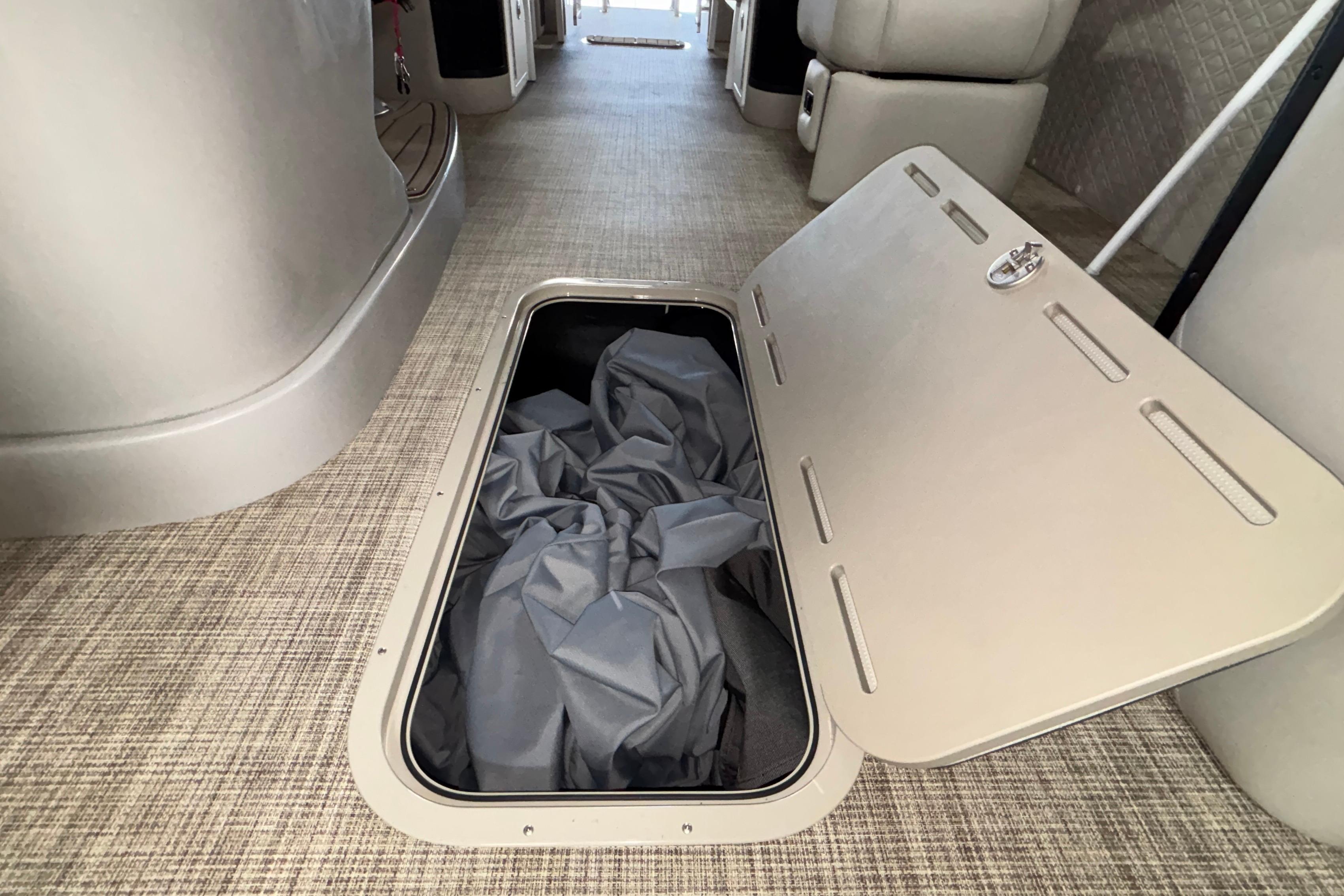 Underfloor storage compartment in 2026 JC Sporttoon 26TT boat interior.