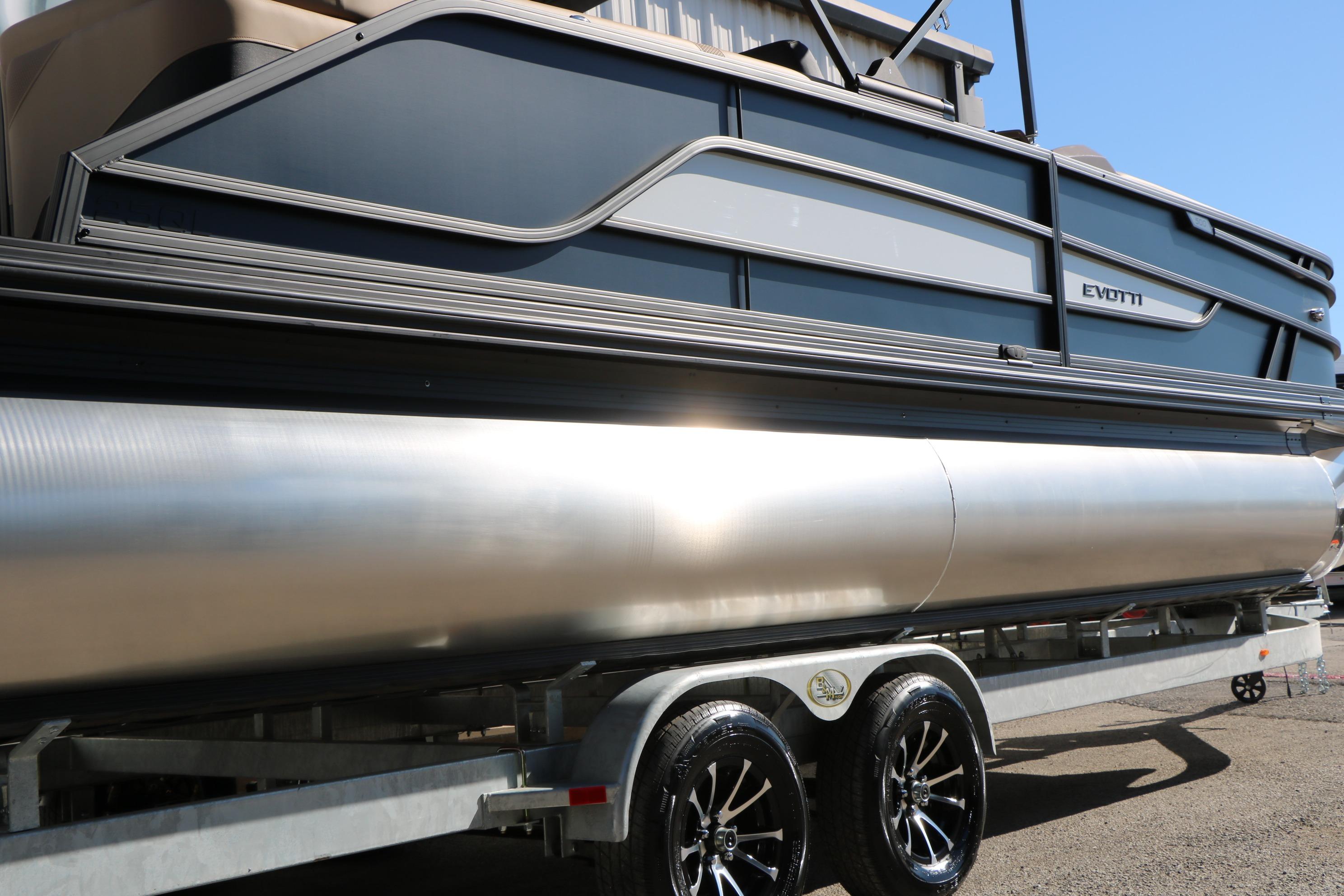 2026 Evotti 525 QL Tri-Toon boat on trailer, sleek design, shiny pontoons.