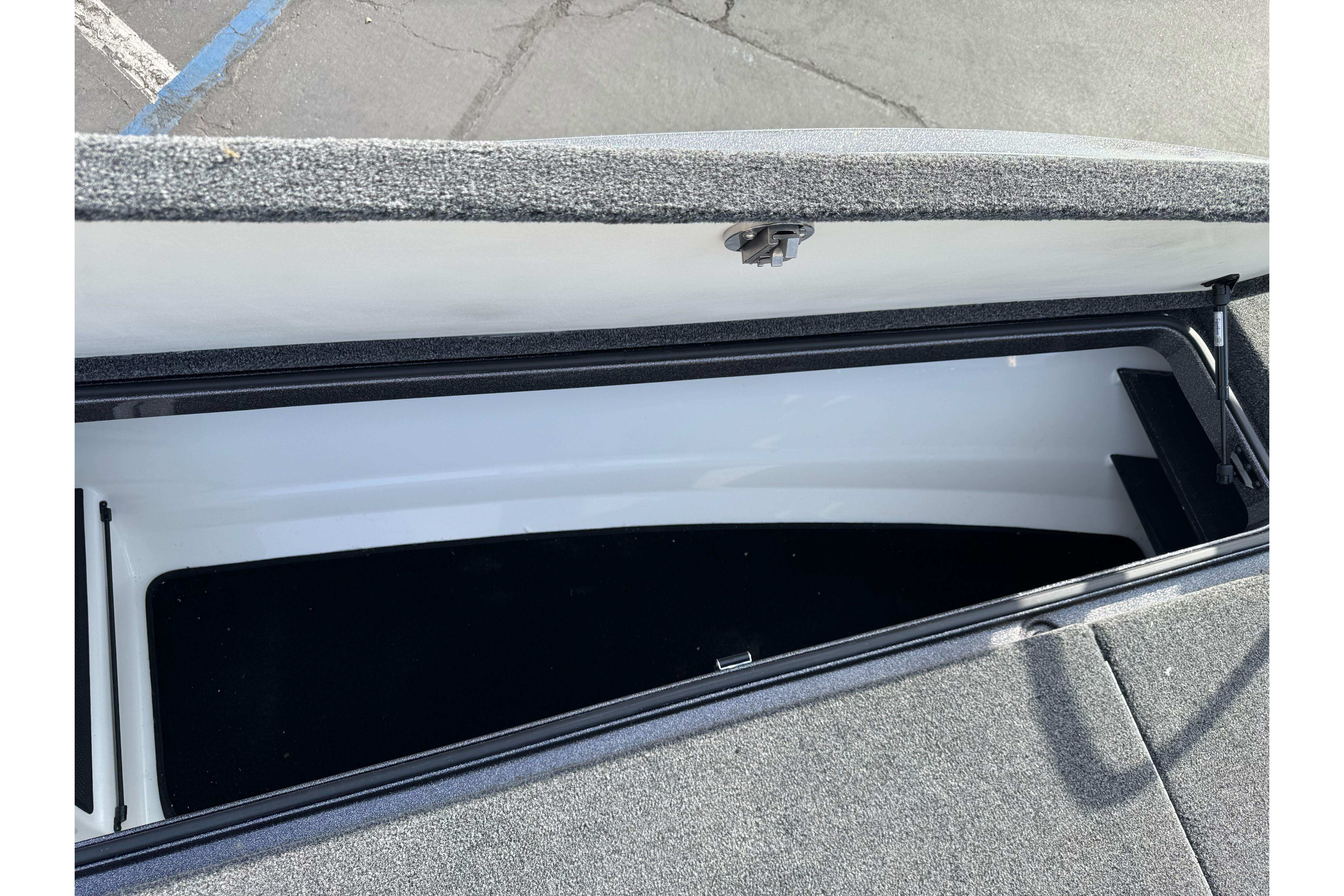 Open storage compartment in 2025 Ranger Z521 boat, showcasing interior space.