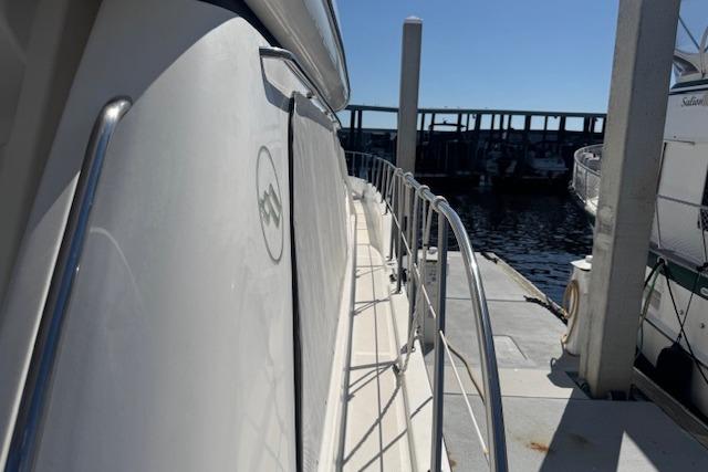 Side view of a 2000 Bayliner 5288 Pilot House Motoryacht docked at a marina.
