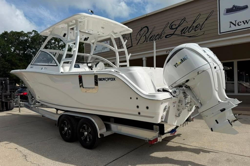2026 Sea Fox 288 Traveler boat on trailer, parked outside a building.