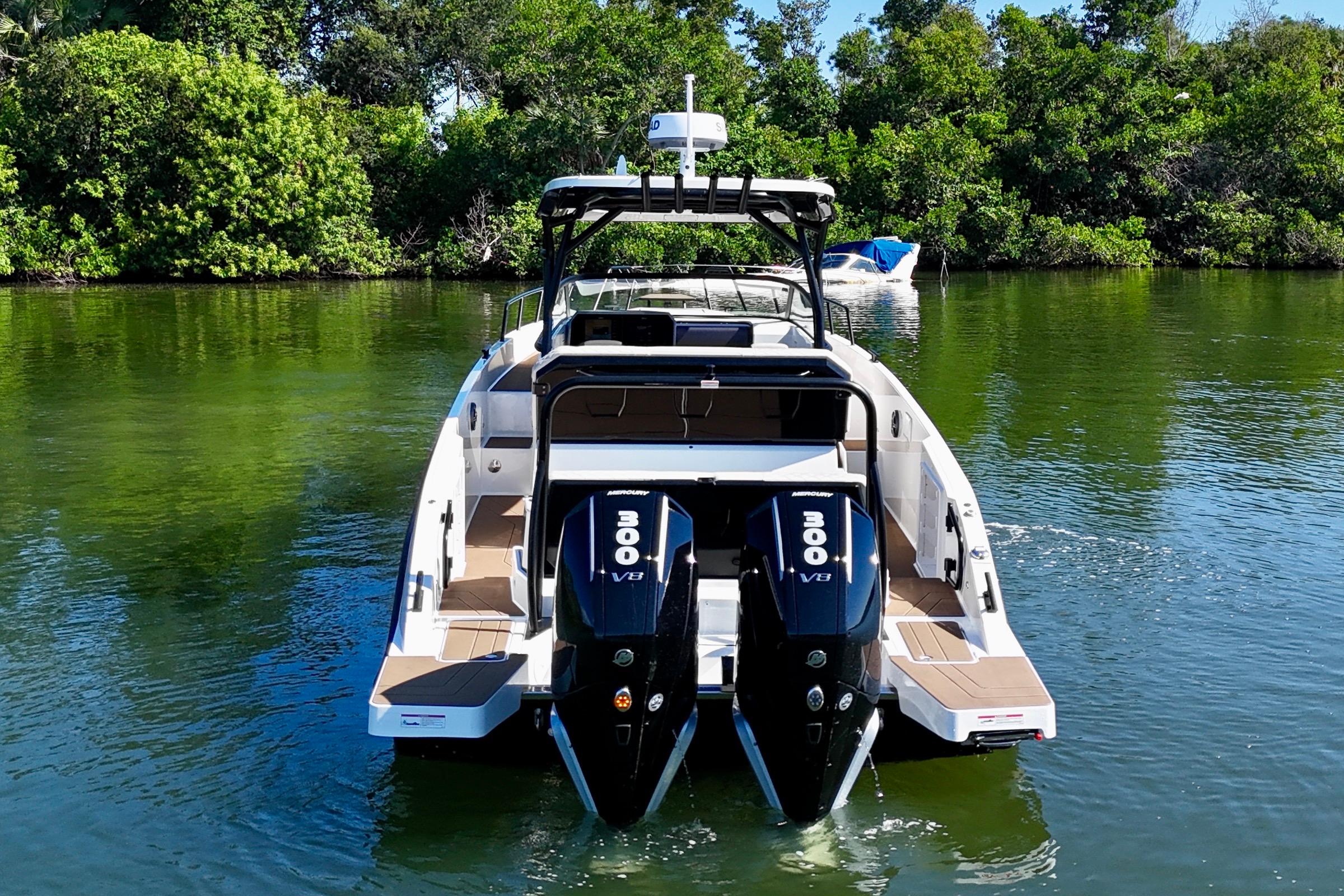 2026 Navan S30 boat with dual 300 V8 engines on a serene waterway.