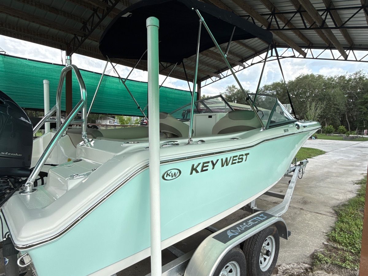 2023 Key West 203 DFS boat on trailer under canopy.