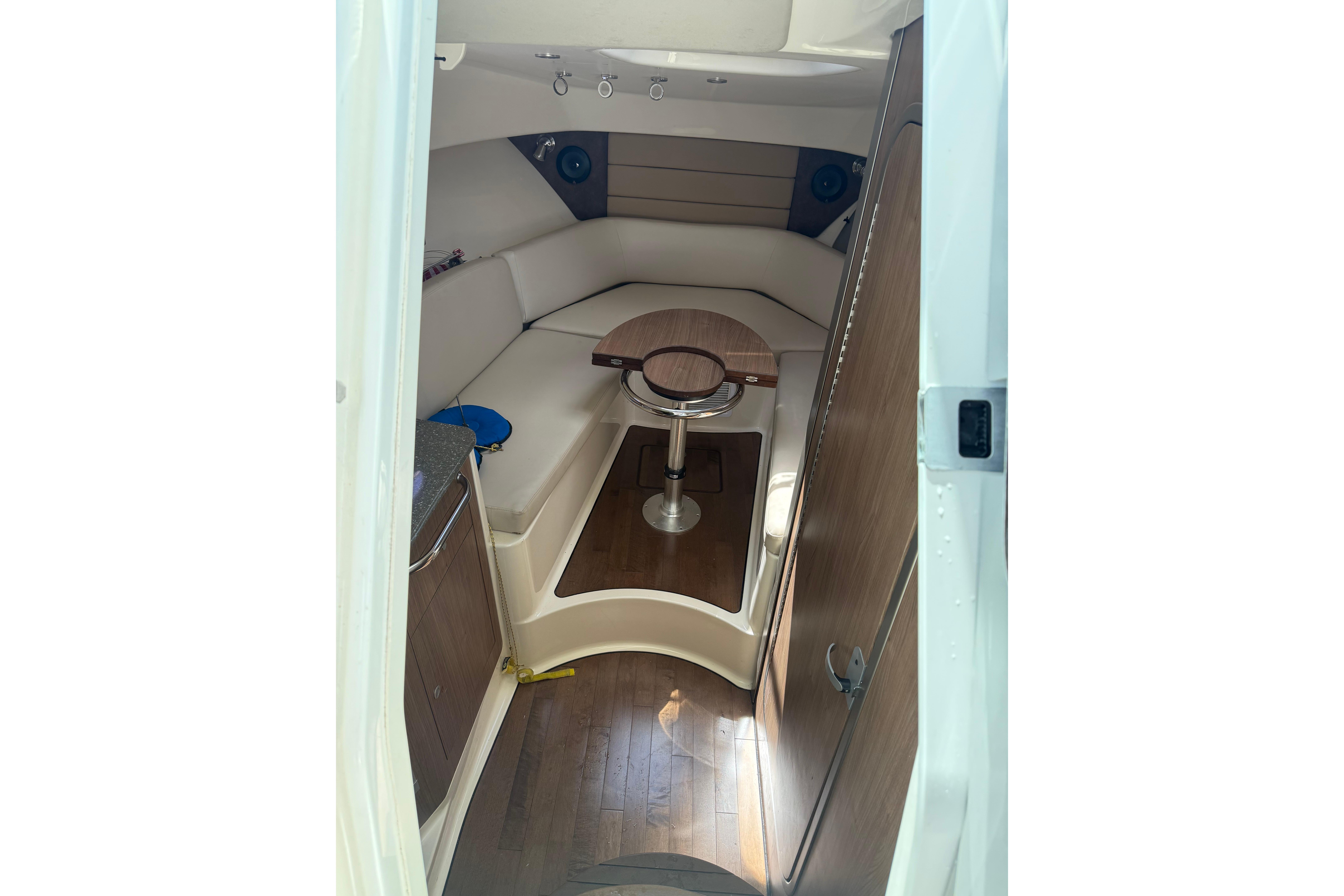 Interior cabin of 2013 Boston Whaler 315 Conquest with seating and table.