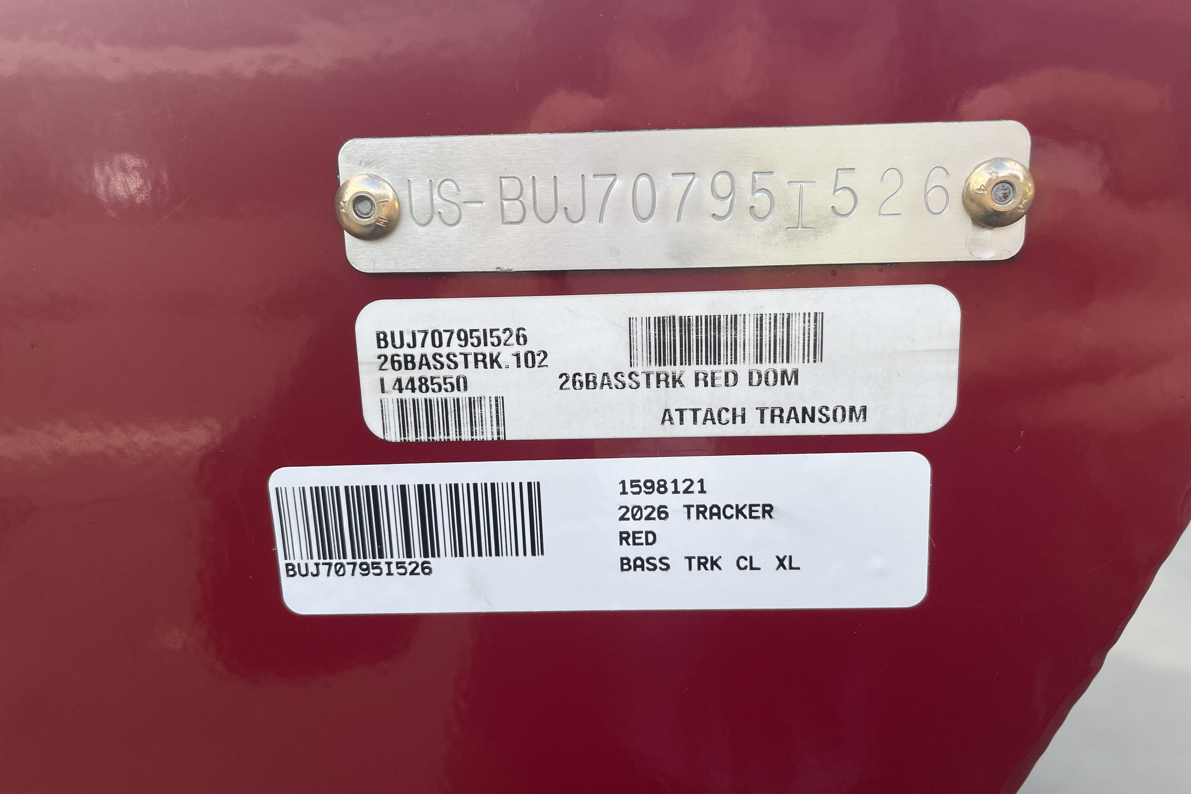 2026 Tracker Bass Tracker Classic XL identification labels on red surface.