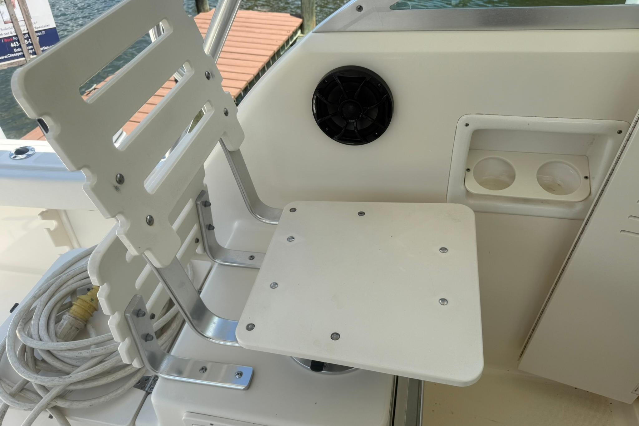 2003 Pursuit 2870 Walkaround boat seat with cup holders and speaker.