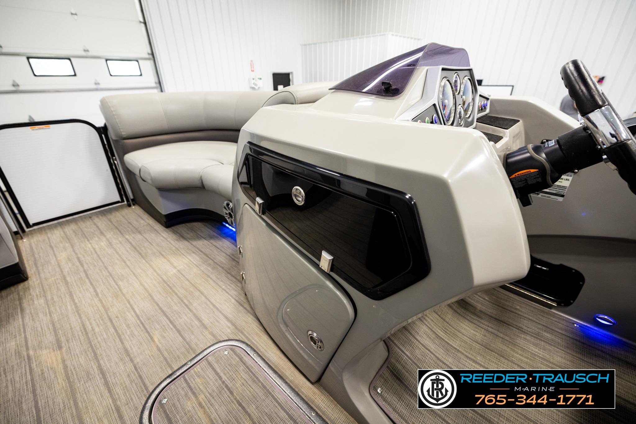 Interior of a 2019 Manitou Oasis SR VP pontoon boat with modern dashboard and seating.