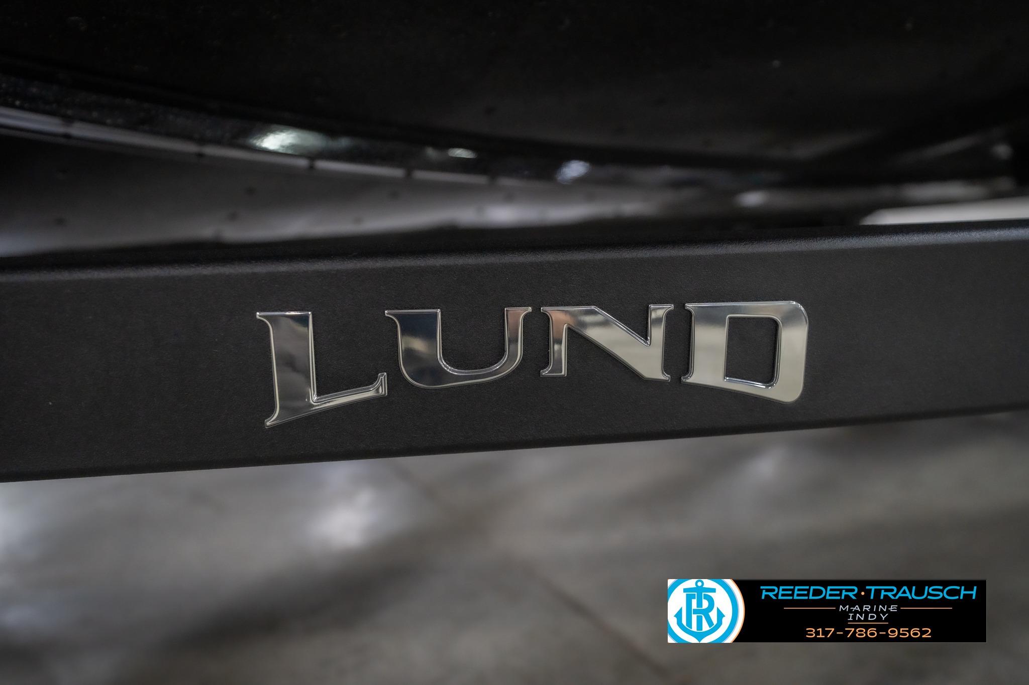 2026 Lund 2075 Impact XS boat logo on black surface, Reeder Trausch Marine contact info visible.