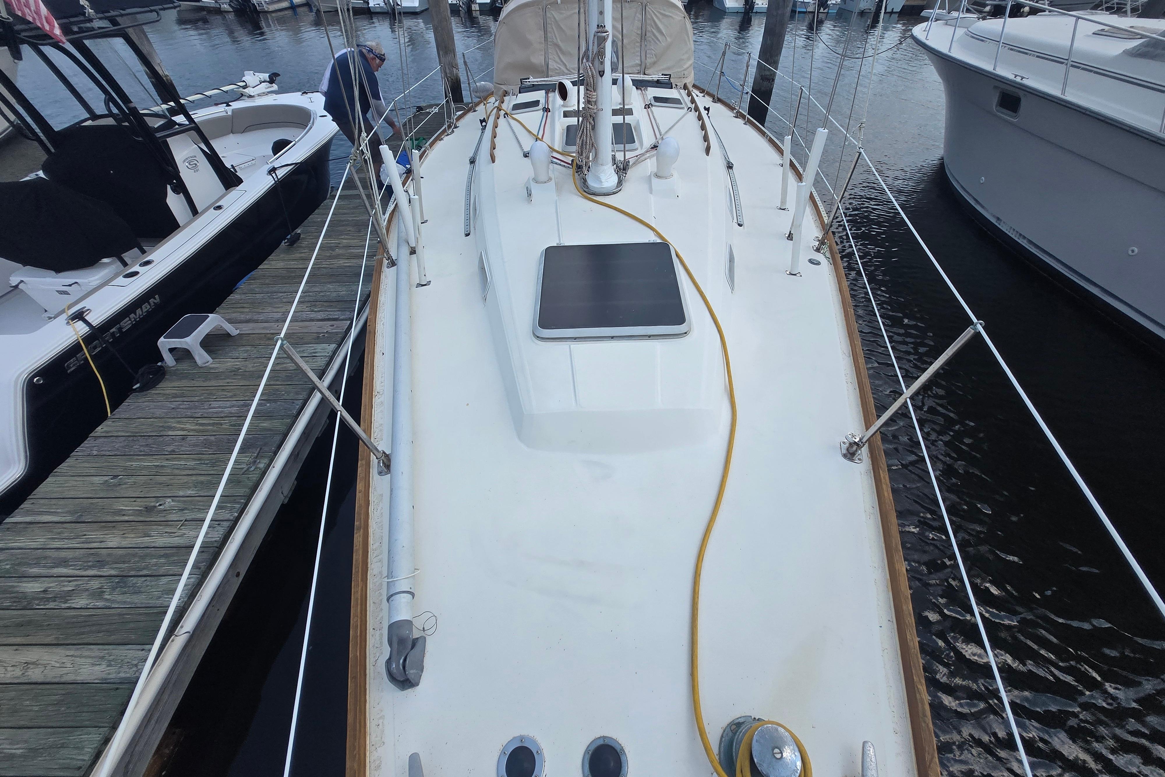 1988 Sabre 38 sailboat docked at marina, viewed from deck, with mooring lines visible.