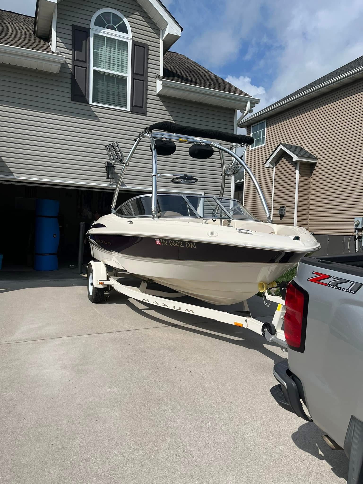 1999 Maxum 1800 SR boat on trailer in driveway.