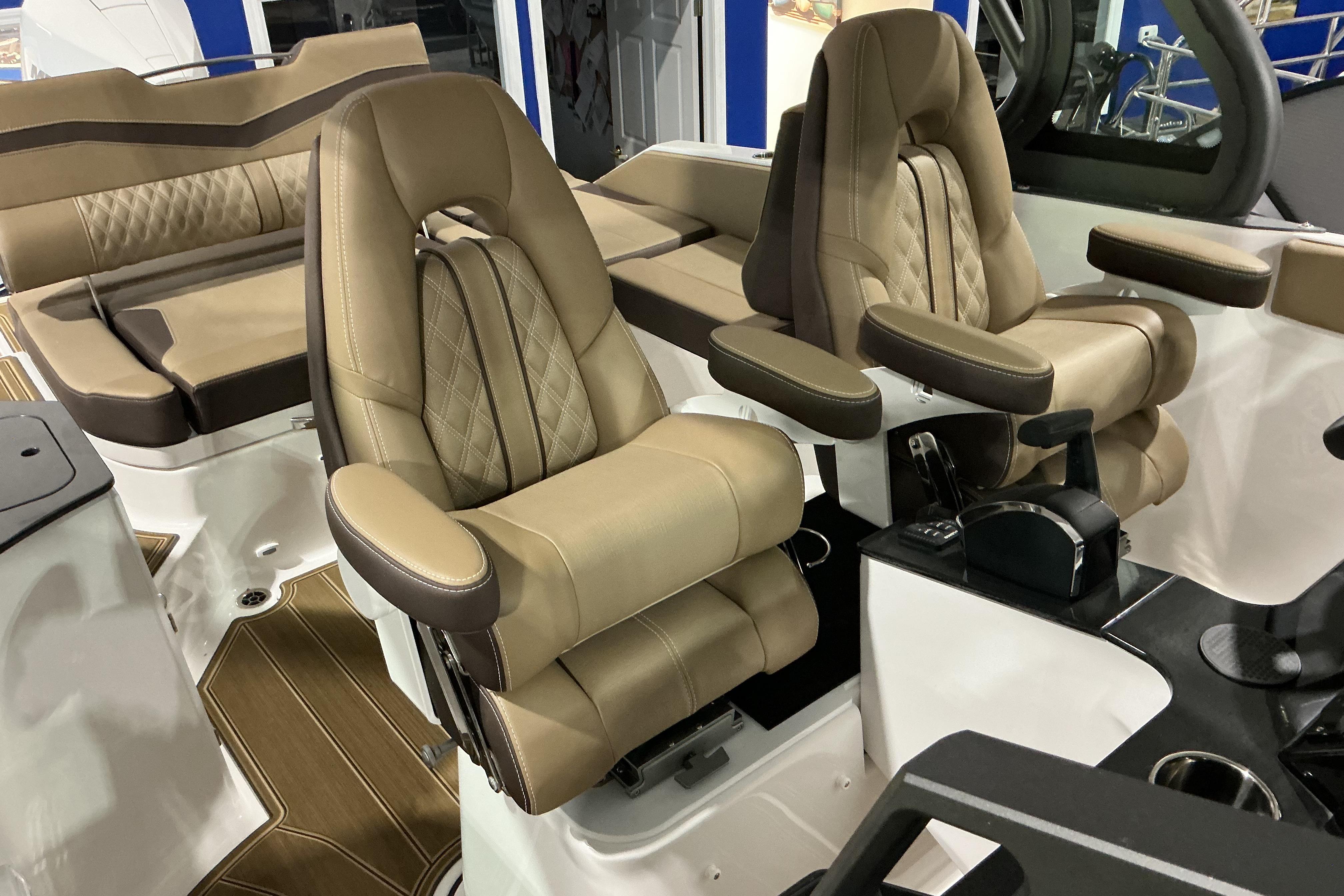 Luxurious seating on the 2026 Monterey Elite 25 OB boat, featuring plush tan upholstery.