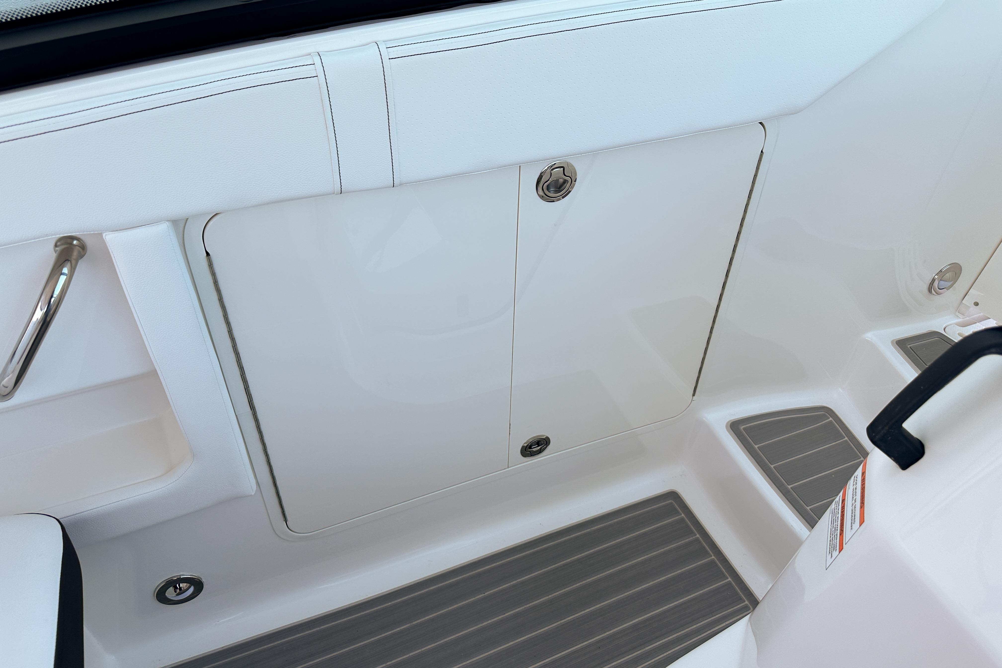 2026 Sea Ray Sundancer 320 boat interior with white seating and storage compartment.
