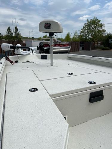 2024 Ranger RB210 boat deck with storage compartments and mounted equipment under a cloudy sky.