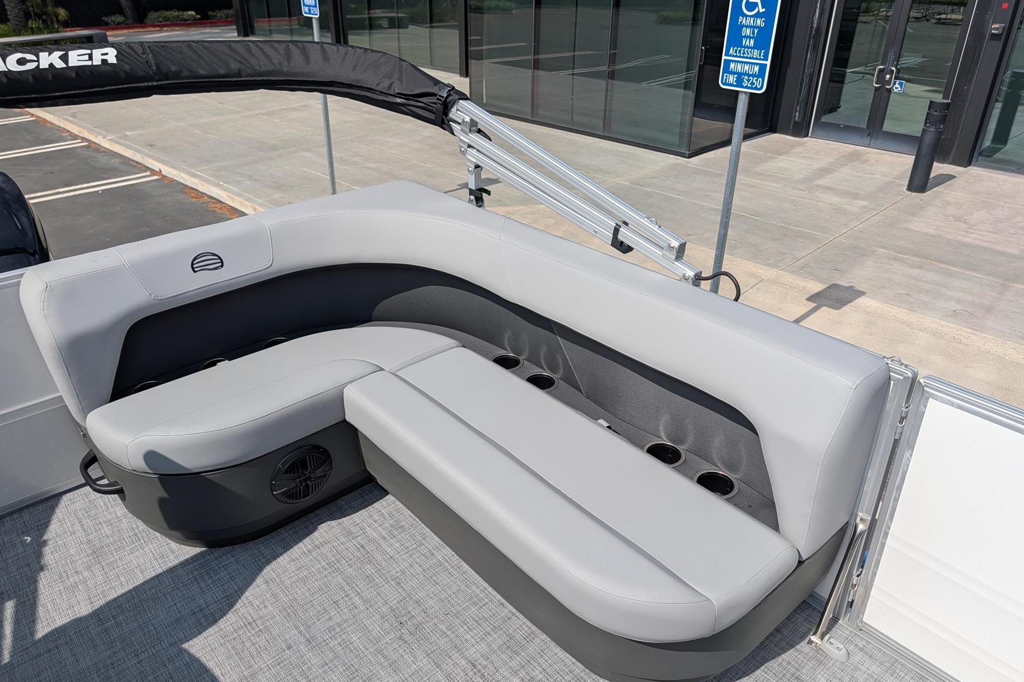 2026 Sun Tracker Party Barge 16 DLX with gray seating and cup holders.