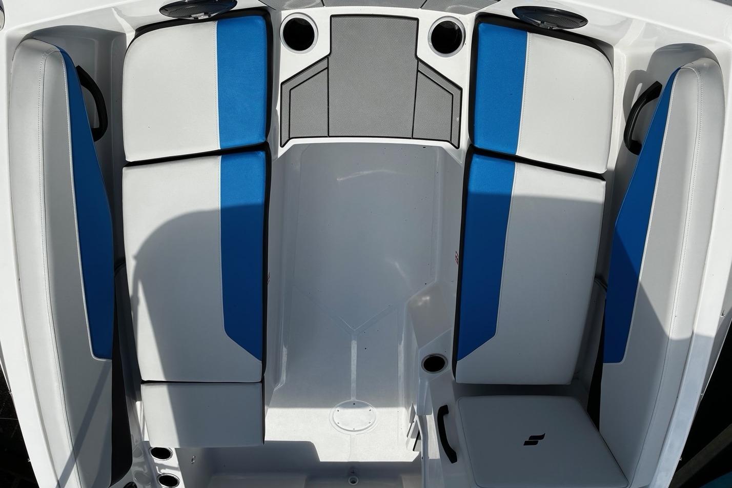 2026 Starcraft SV 16 OB boat interior with blue and white seating and cup holders.