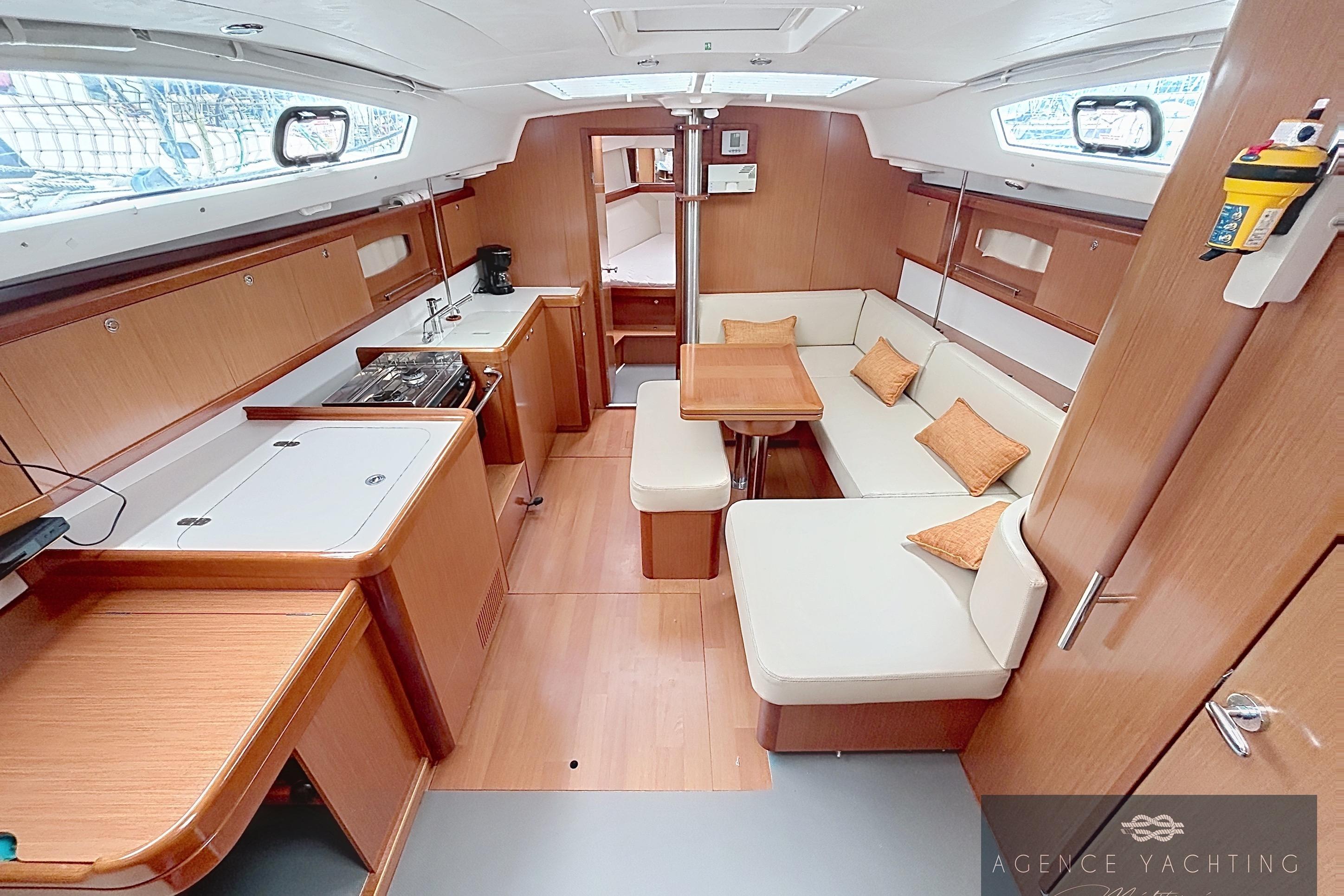 Interior of 2008 Beneteau Oceanis 40 yacht with modern kitchen and cozy seating area.