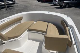 2023 Trophy T24 CC boat interior with beige seating in a parking lot.