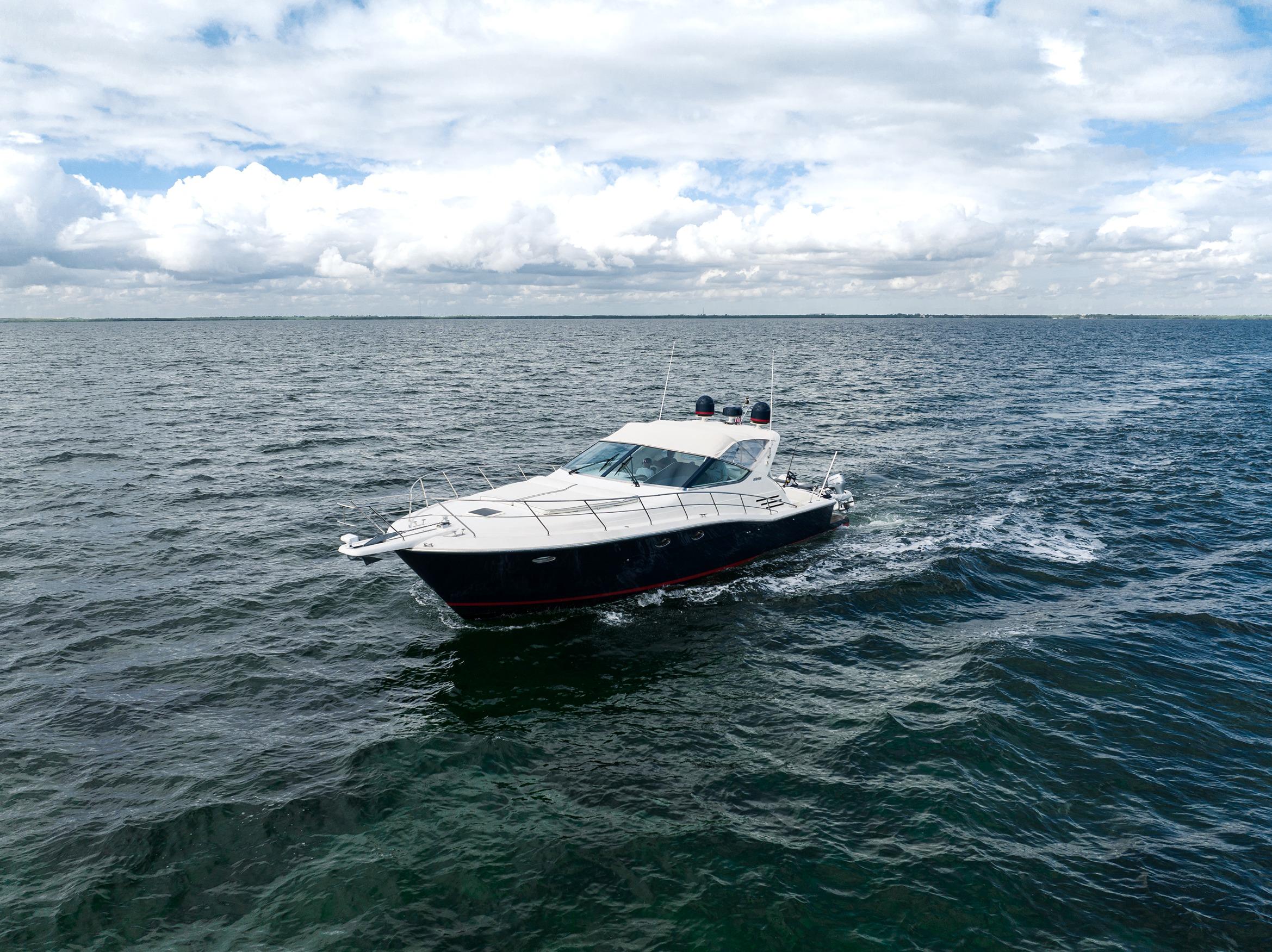 Uniesse 48 Open 2001 yacht cruising on open sea under cloudy sky.