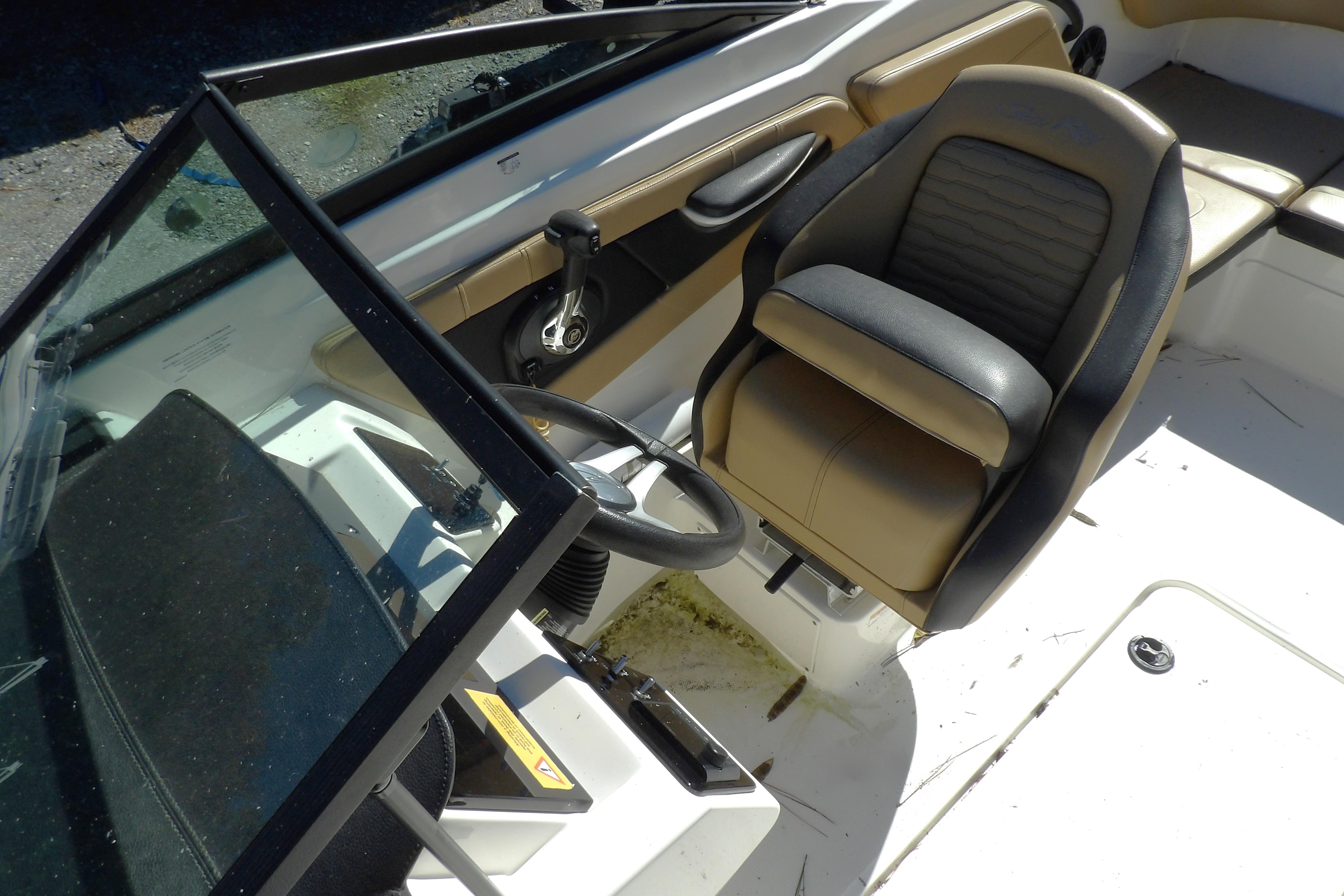 2023 Searay 210 SPO boat interior with steering wheel and seating.