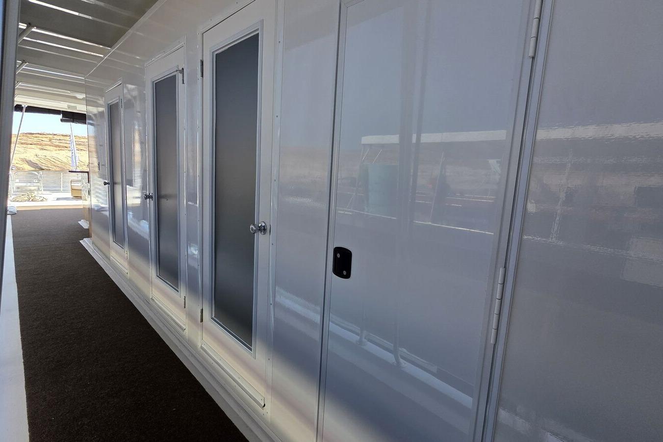 2025 Sumerset Excellence Multiple Shares houseboat corridor with sleek white doors and modern design.