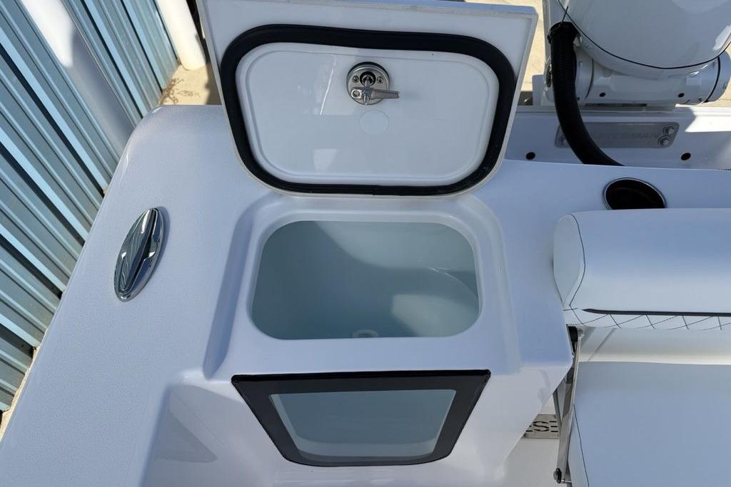 2026 Sportsman Open 232 Center Console boat with open storage compartment.