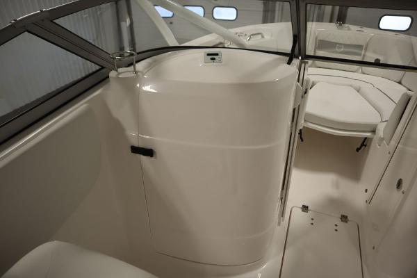 Interior view of 2025 Sea Fox 228 Traveler boat, featuring sleek white design and seating area.