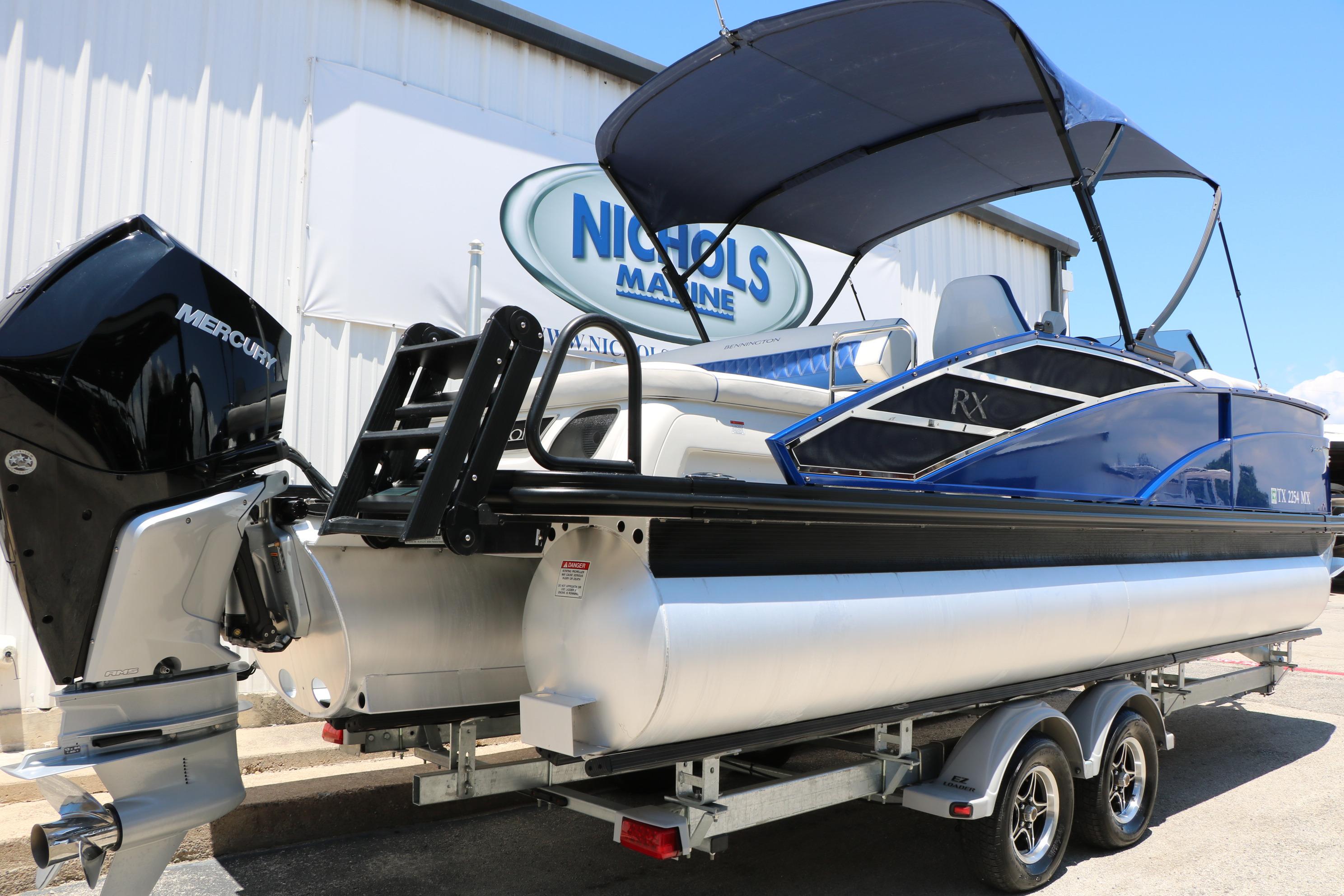 2024 Bennington 23 RX Swingback pontoon boat with Mercury engine on trailer.