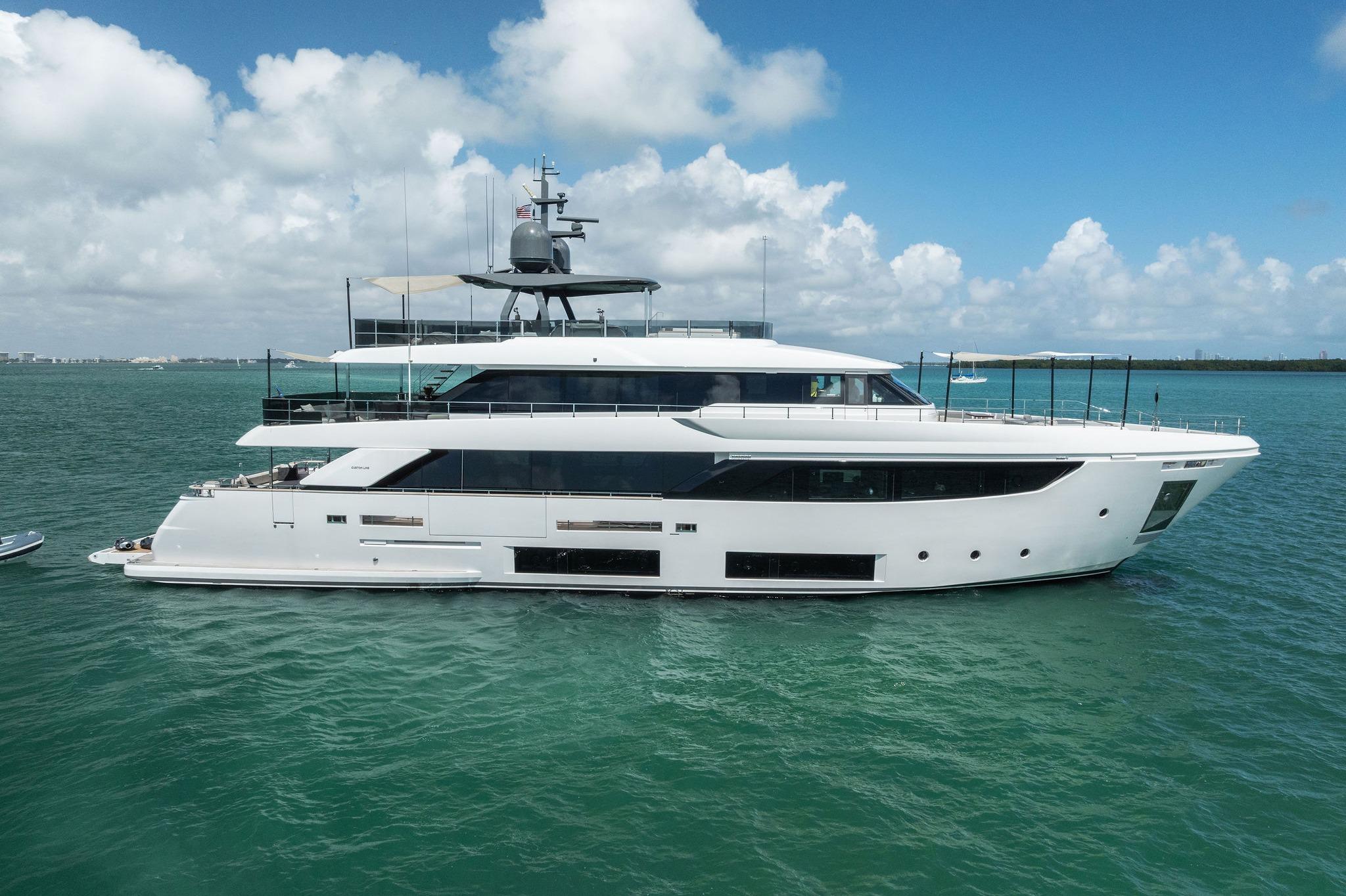 Luxurious 2023 Custom Line Navetta 33 yacht cruising on clear blue waters.