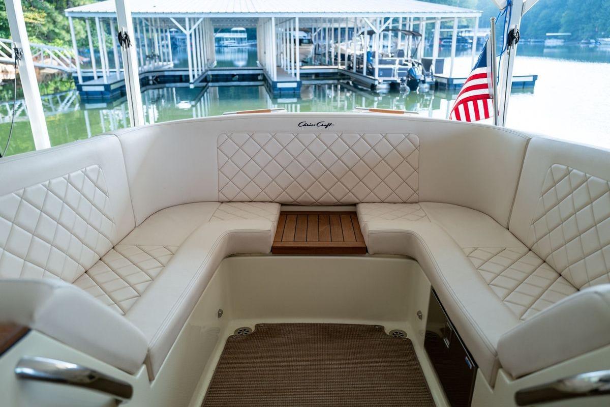 2023 Chris-Craft Launch 27 boat interior with elegant white seating and wooden accents.