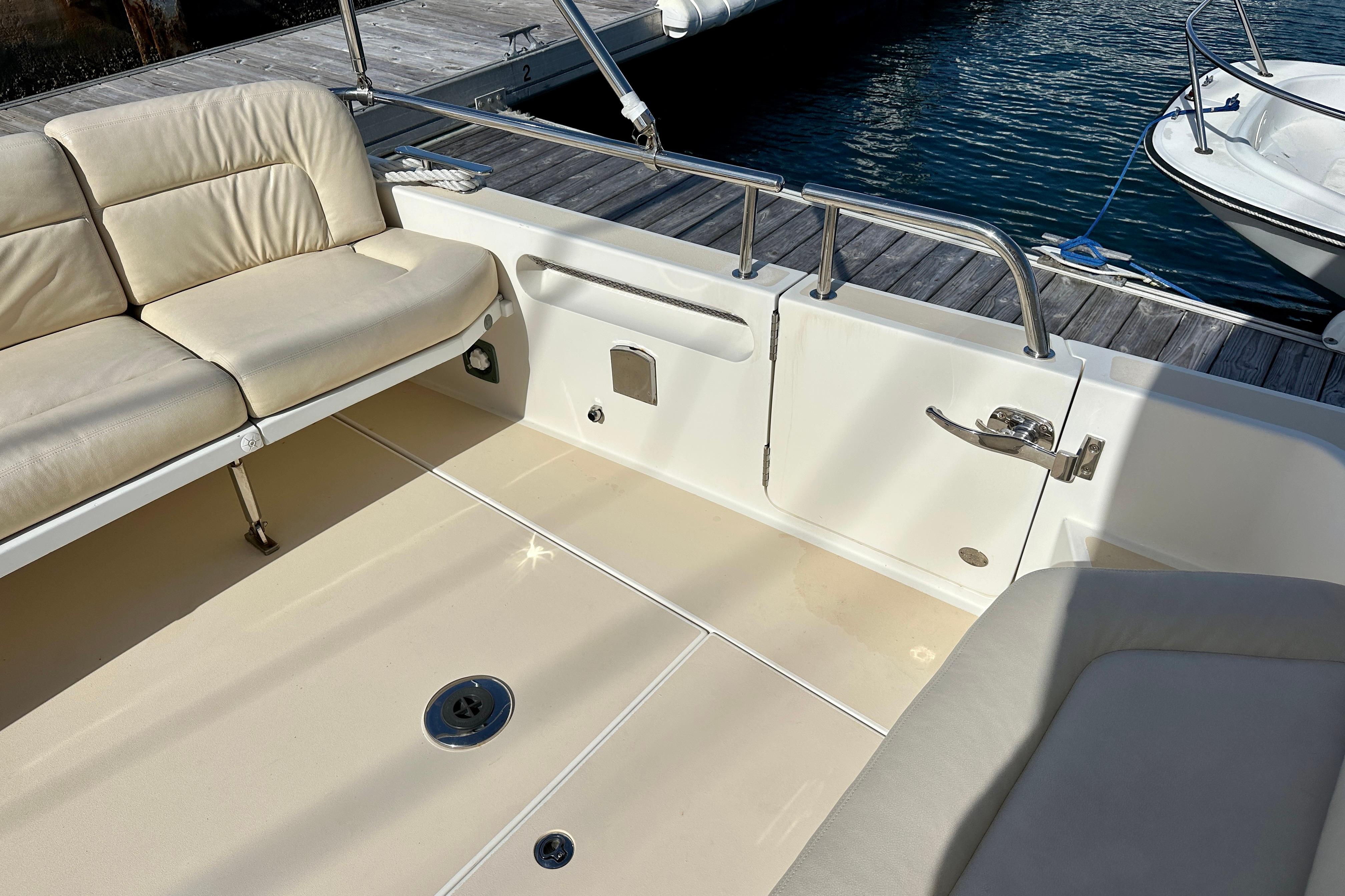 2014 MJM 40z boat interior with beige seating and dock view.