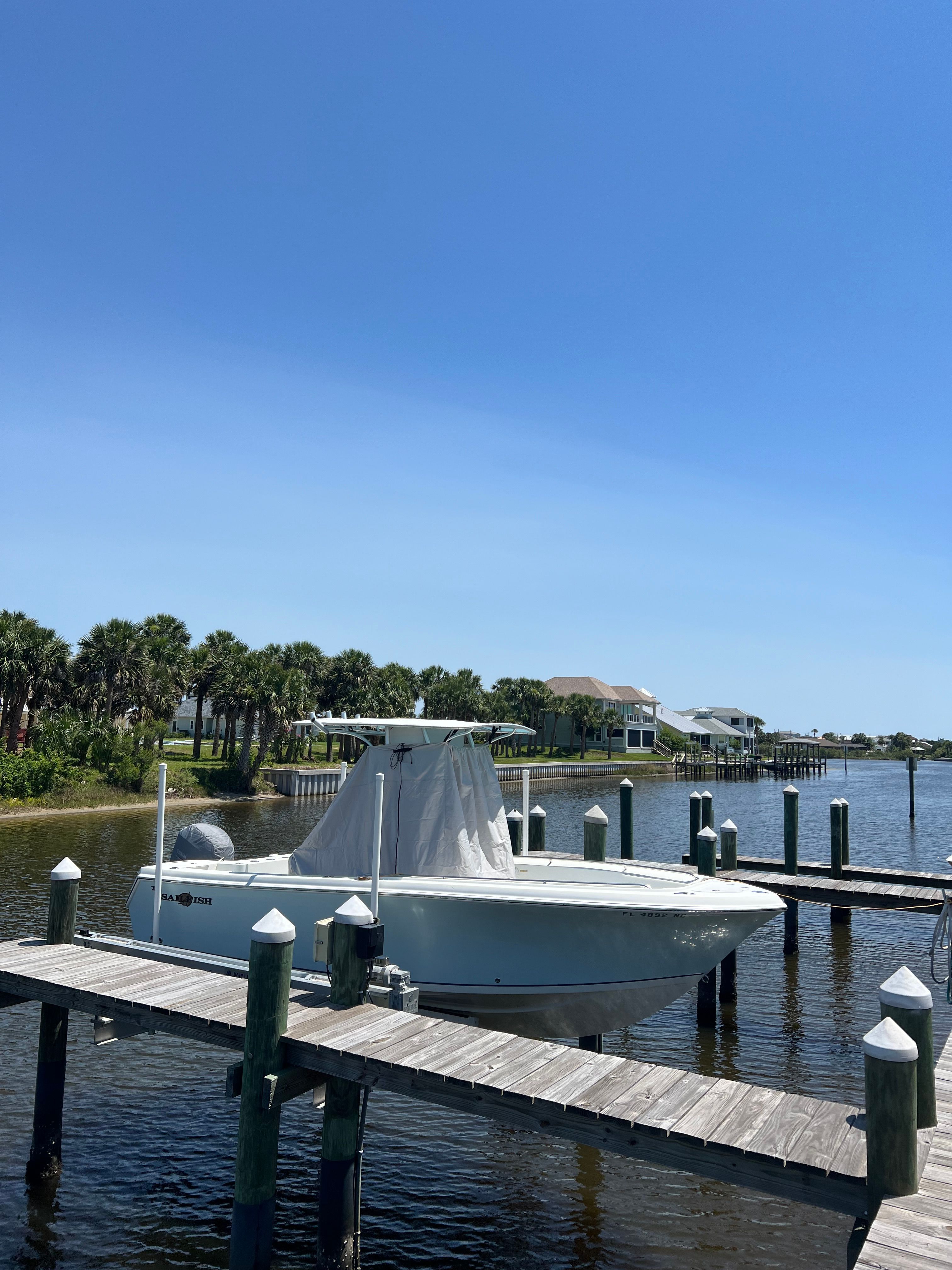 2006 Sailfish 218 CC boat docked on a sunny day.