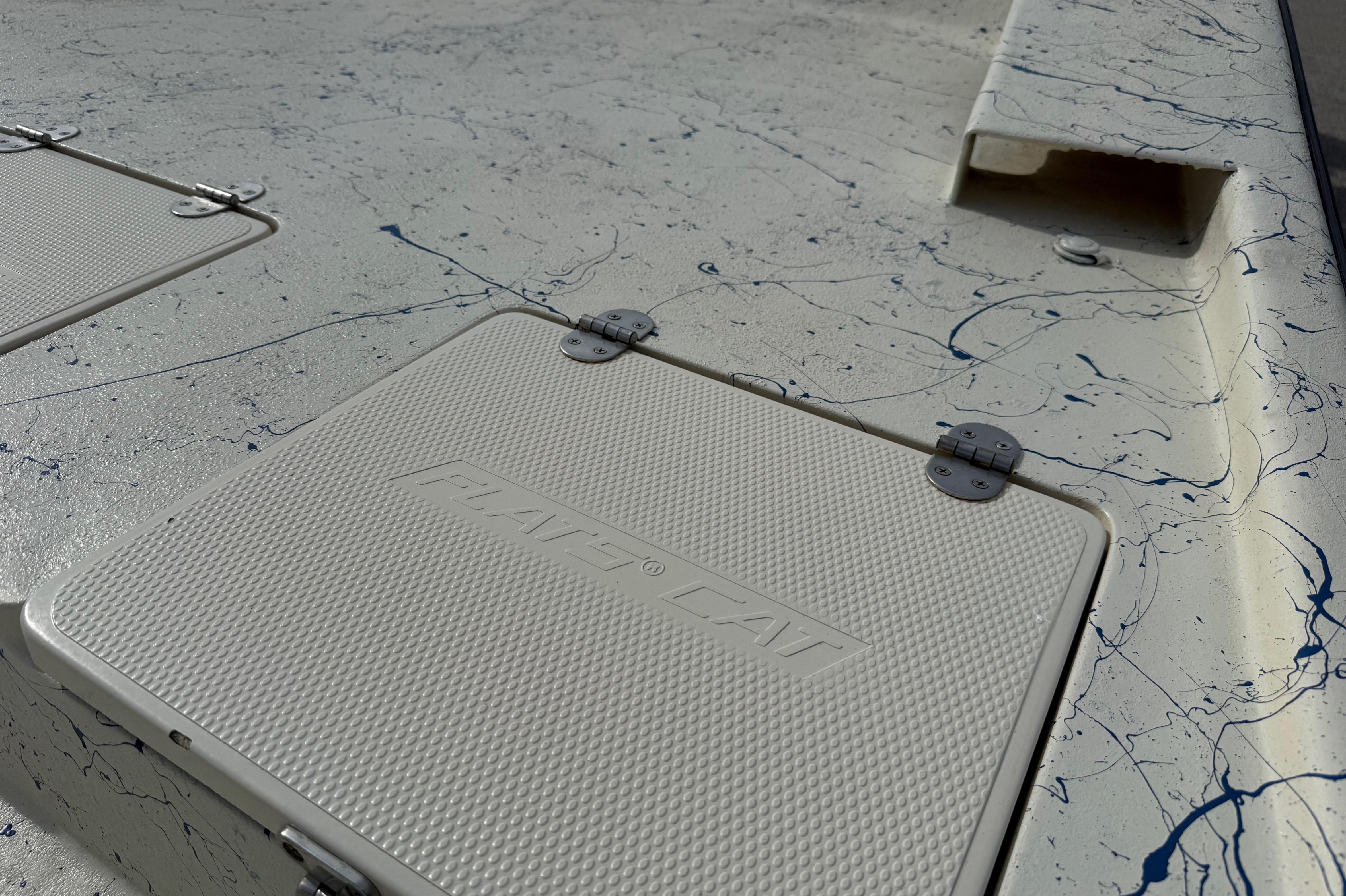 Close-up of a 2007 Flats Cat 19 boat deck with textured hatch covers.