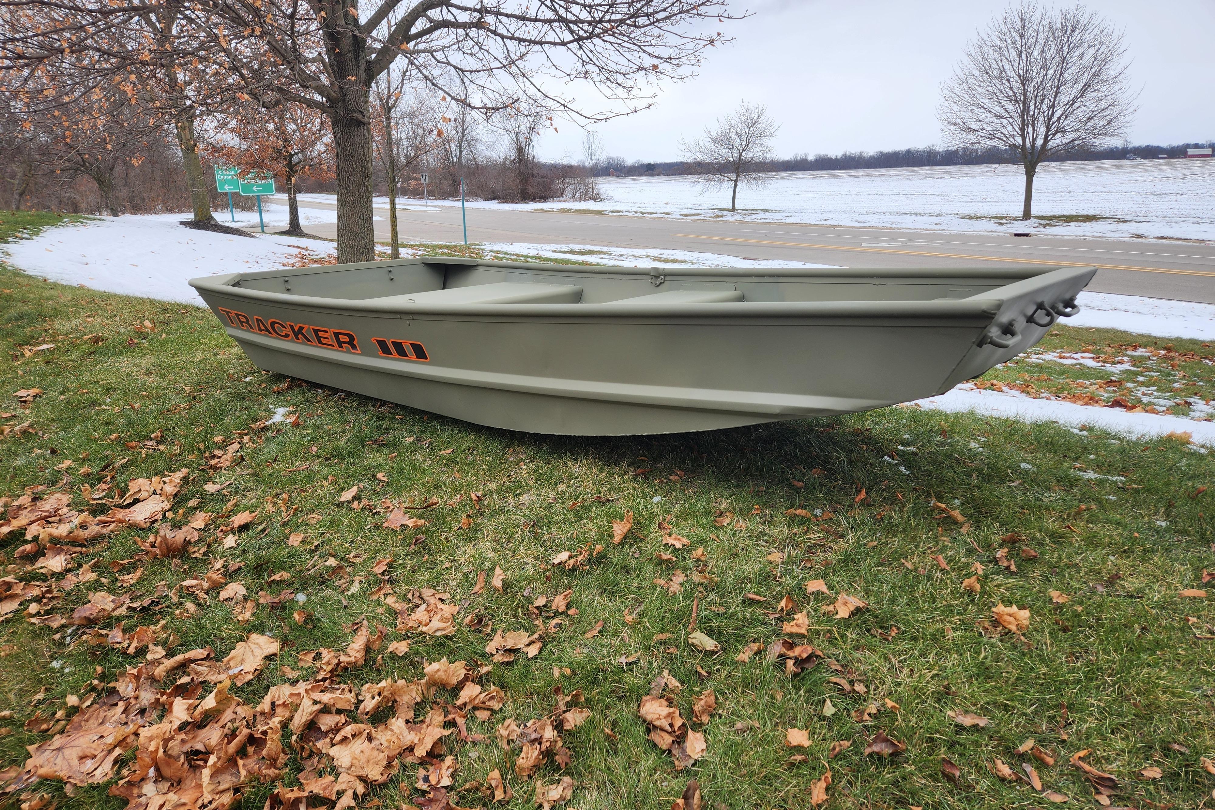 2026 Tracker Grizzly 10 Jon boat on grass, surrounded by autumn leaves and light snow.