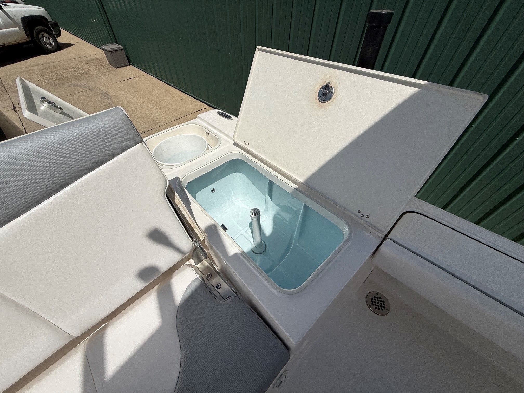 2021 Robalo 226 Cayman with open storage compartment and seating area.