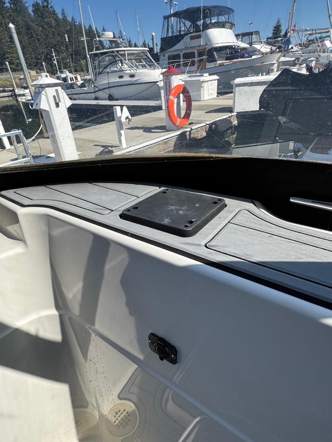2003 Meridian 381 Sedan interior view at marina, surrounded by boats and clear blue sky.