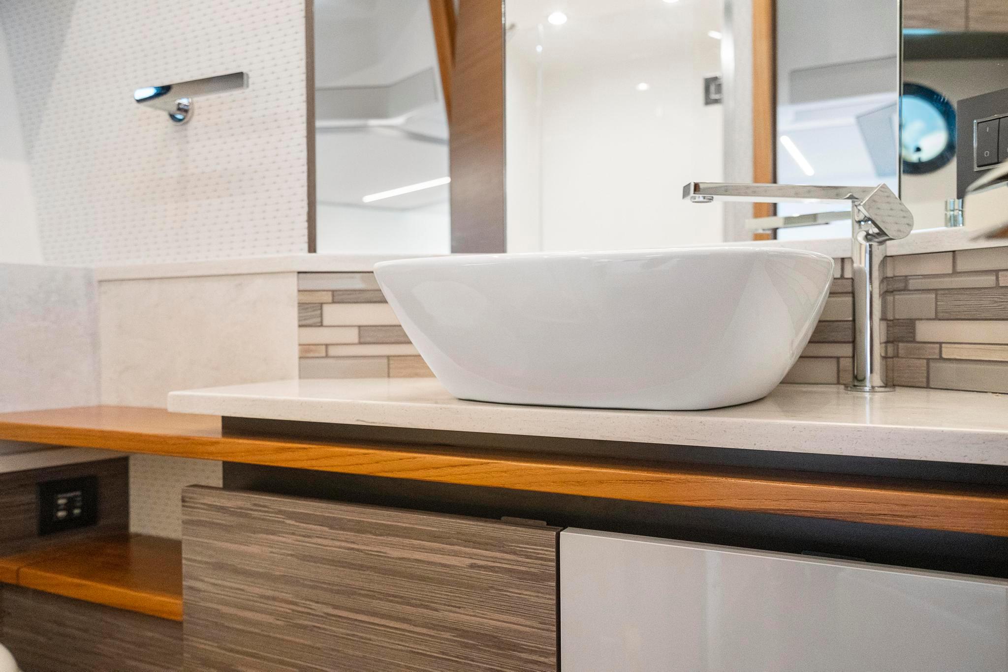 Modern bathroom sink in 2022 Tiara Yachts C49 Coupe, featuring sleek design and elegant fixtures.