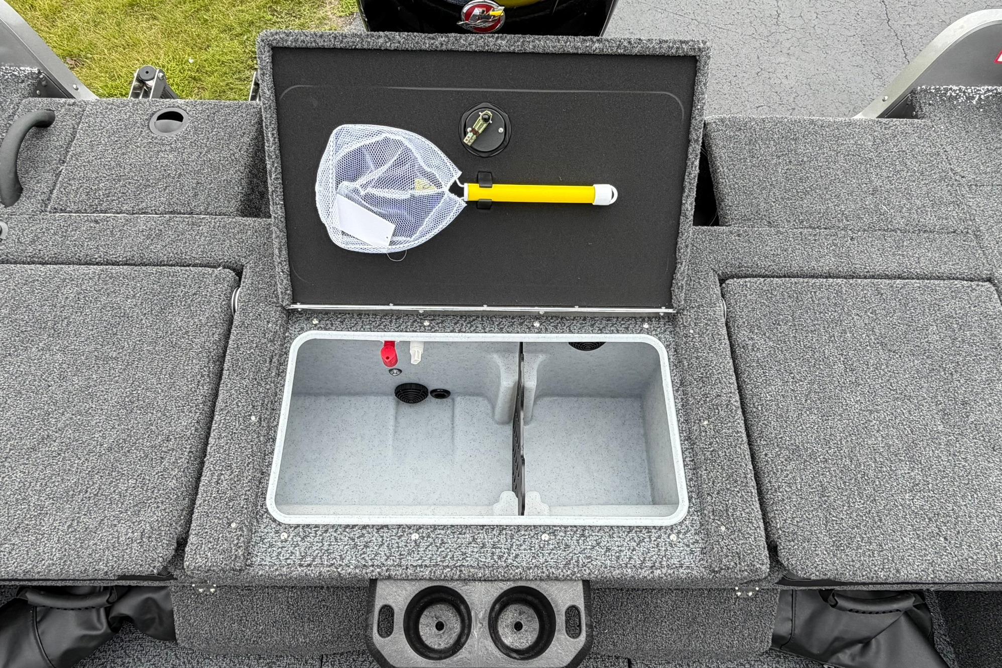 Open storage compartment on 2027 Lund 1875 Impact XS Sport boat with fishing net.