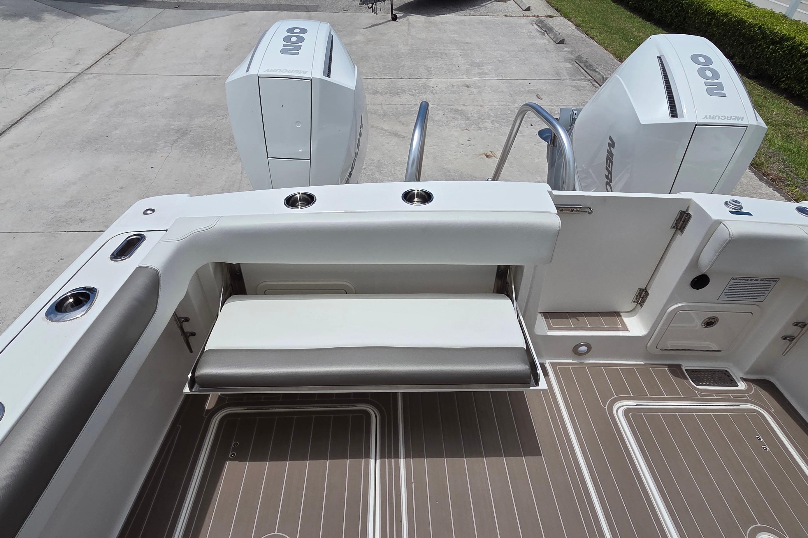 2023 World Cat 280 DC-X boat deck with seating and twin Mercury engines.