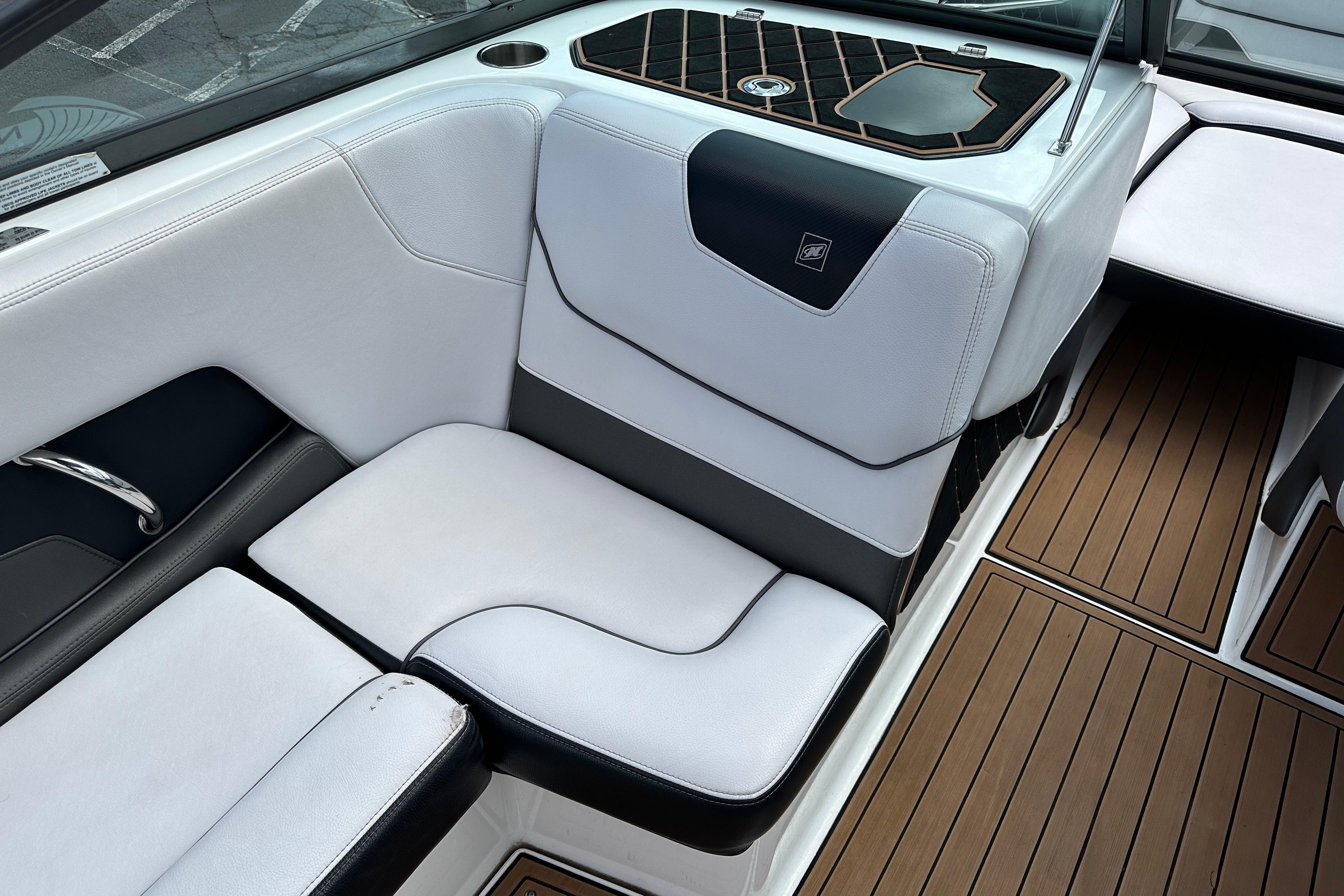 2017 Nautique Super Air Nautique GS20 interior with white seating and teak-style flooring.