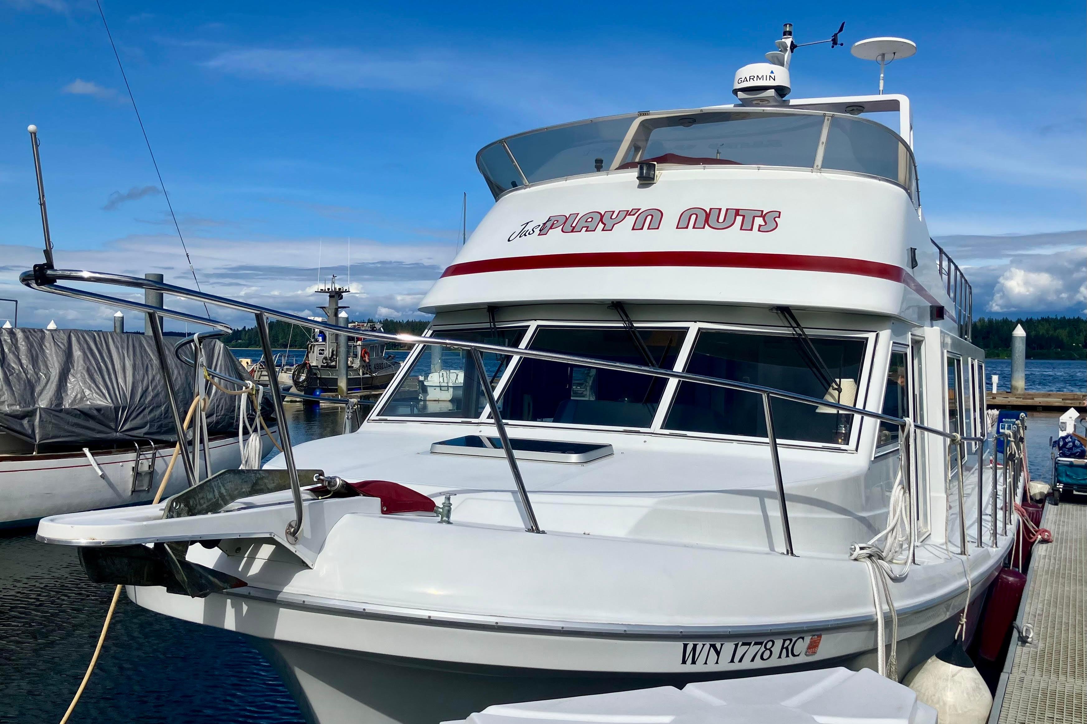 1992 Cruise-A-Home Corsair 4200 boat docked at marina under clear blue sky.