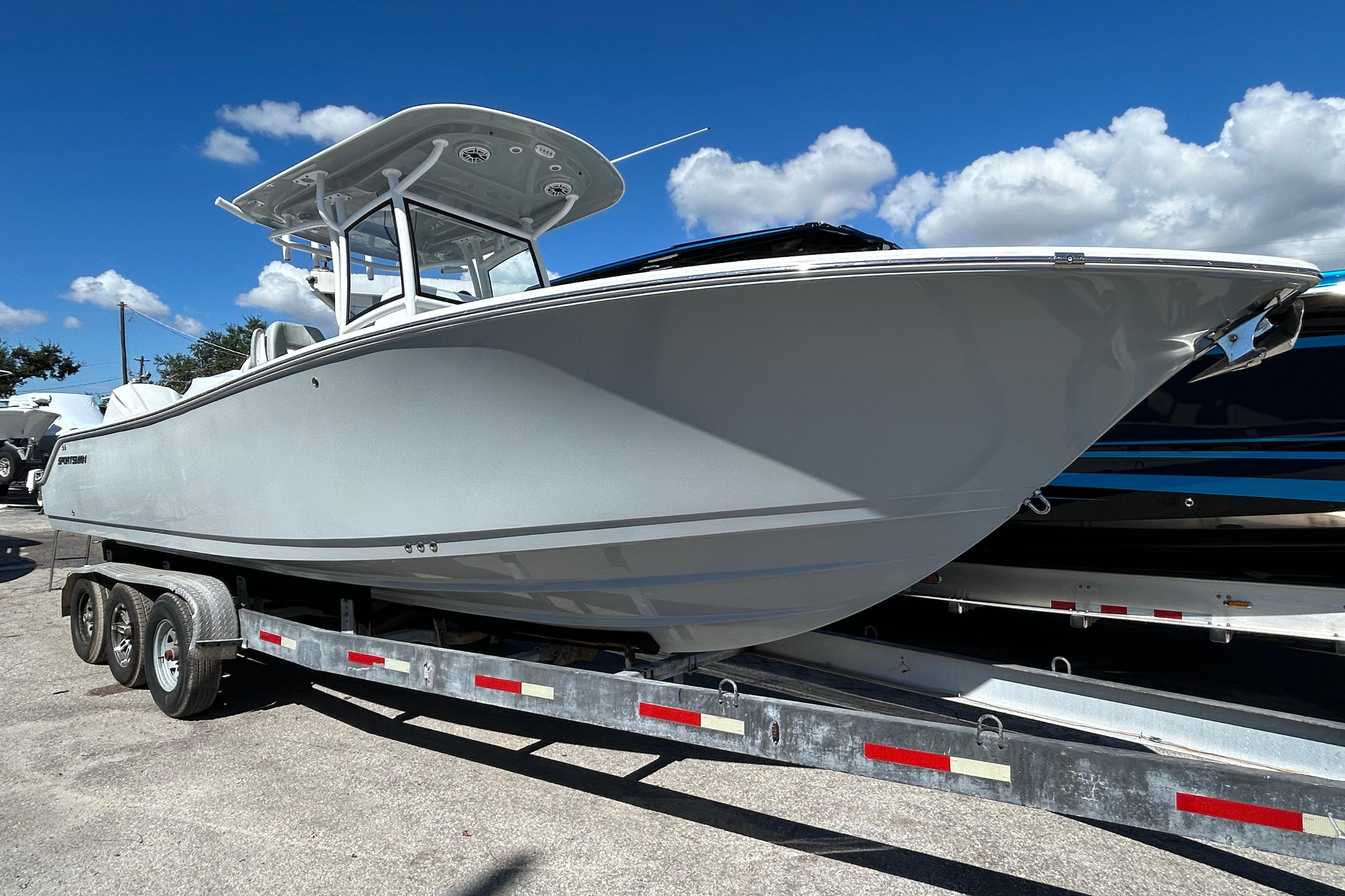 2019 Sportsman Open 282 Center Console boat on trailer under blue sky.