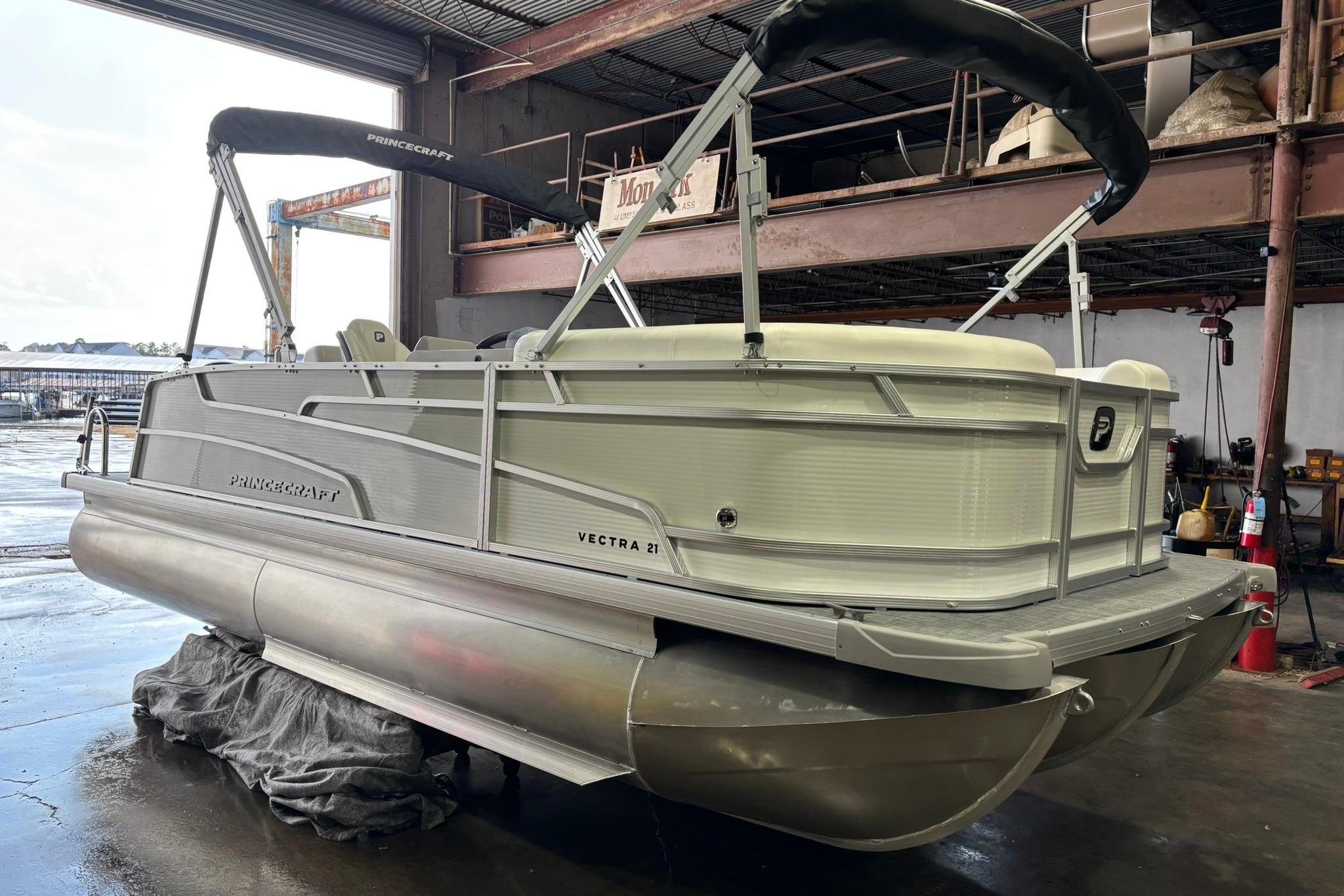 2025 Princecraft Vectra 21 RL pontoon boat in a warehouse setting.