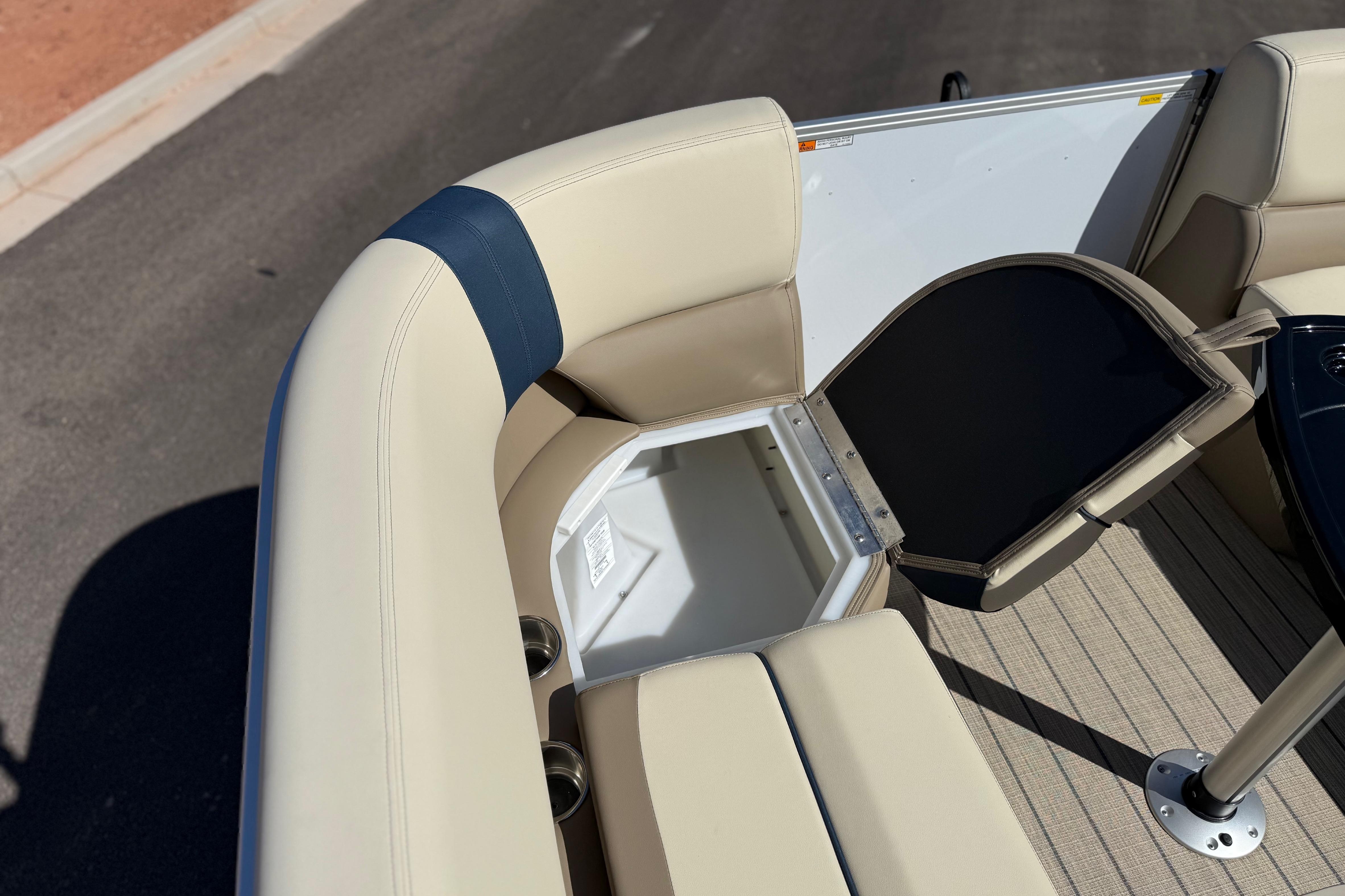 SunCatcher Select 322SL 2026 boat interior with open storage compartment and beige seating.