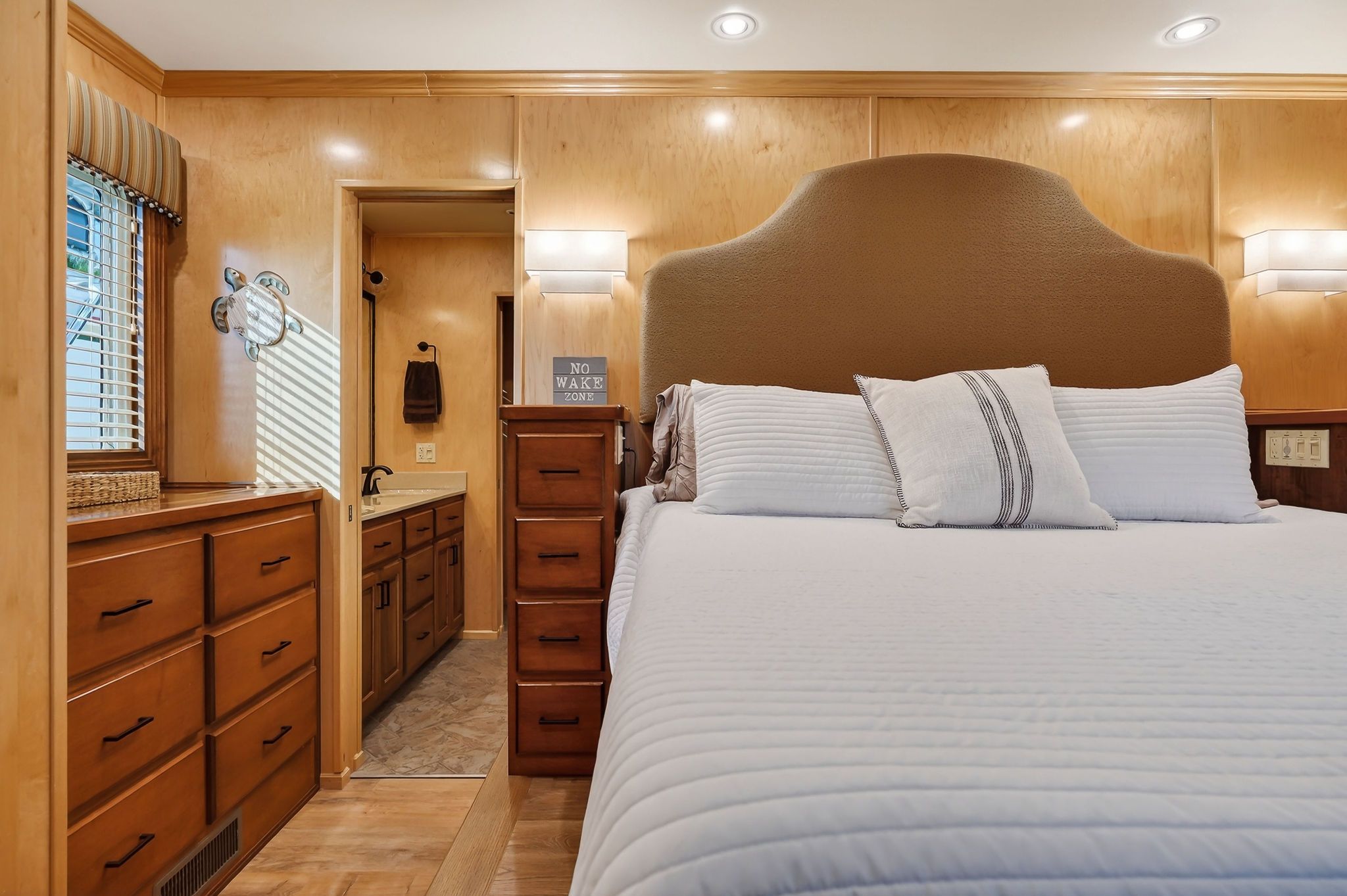 2010 Houseboat Throughbred bedroom interior with wooden furnishings.