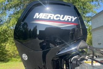 Mercury outboard motor on 2026 Sun Tracker Party Barge 18 DLX, outdoors.